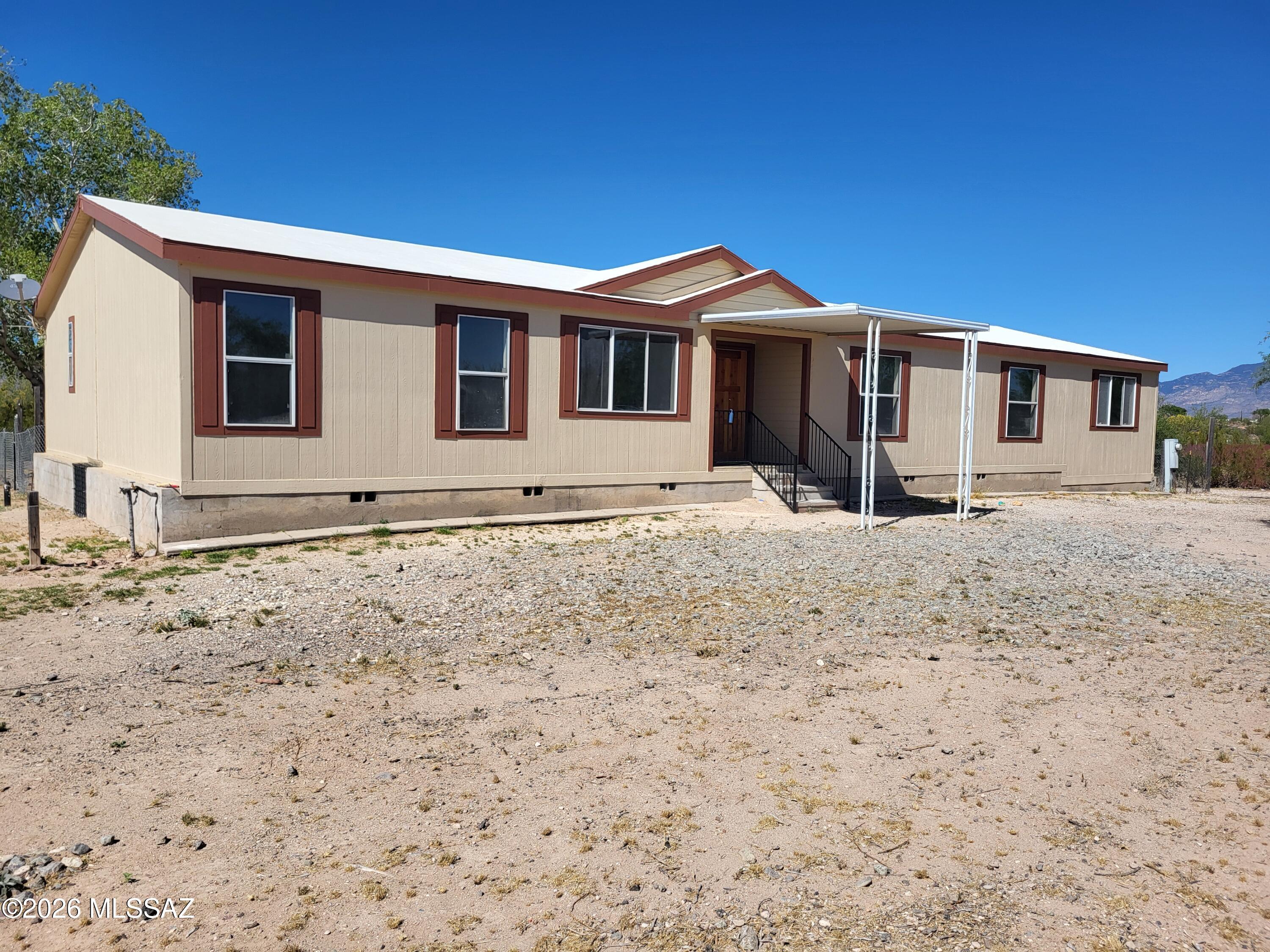 Freshly remodeled and move-in ready, this 2004 Champion manufactured home offers space, flexibility, and rural charm on a full 1-acre lot with Vail GR-1 zoning. Featuring 4 bedrooms, 3 full baths, a split floor plan, and multiple living areas including a huge recreation room, living room, and great room--there's room for everyone. Updates include new flooring, fresh paint, and a beautifully refreshed kitchen. Plenty of space for equipment, toys, RVs, or future projects. Enjoy wide-open skies, privacy, and the freedom of rural living while still being within reach of town. A rare find with room to grow!