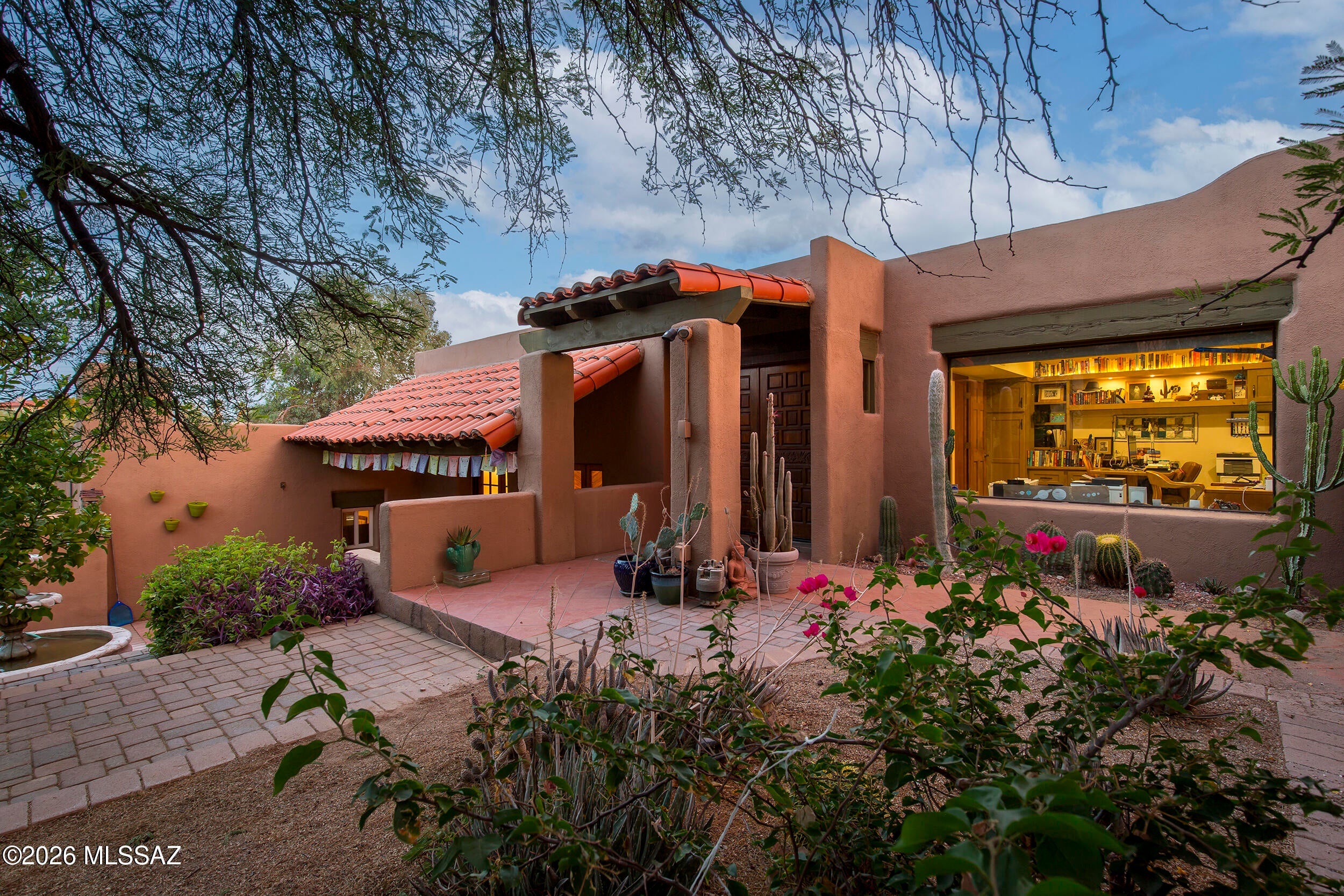 Beautiful Santa Fe home in Catalina Foothills.  Set amongst natural desert w/amazing mountain and city views, this home offers peace and tranquility on nearly an acre.  3Br, 2ba w/office has great natural sunlight throughout and is great for entertaining w/four separate patios.  Amazing hiking trails outside the door. Kitchen includes stainless steel appliances, Engineered wood flooring on mid & lower levels w/a thick adobe wall (entry).  Exposed wood beams in living rm/beautiful beehive fireplace overlooks a stunning patio space.  A short distance to great restaurants, hiking, Whole Foods and outdoor activities & Tucson Medical Center.
