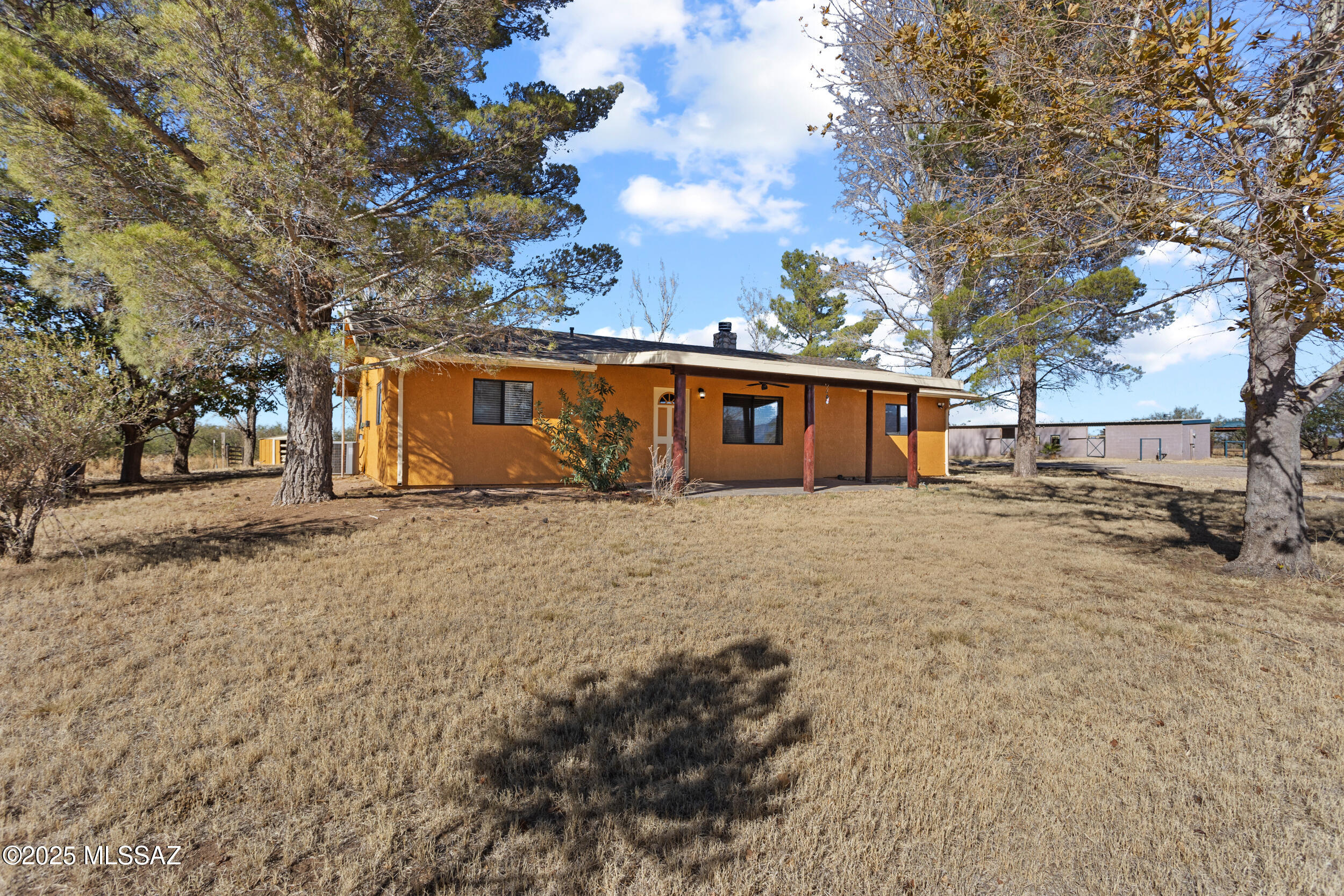 Escape to your own Southwest paradise with this charming 3-bedroom, 2-bath home nestled on 40 acres of useable land with a private well. Featuring a large detached garage, horse facilities, tack room, and additional outbuildings, this property is ideal for anyone seeking space, and room to ride. Inside, you'll find a spacious open-concept living room with a gas wood-burning fireplace that adds warmth and ambiance. The large kitchen is perfect for gatherings and is styled with Southwest charm, offering ample room for cooking and entertaining. The split floor plan provides privacy from guests with the kitchen and living being the heart of the home. With room to roam and breathtaking surroundings, this home is a perfect blend of comfort and rustic elegance. Welcome to Lion Heart Ranch
