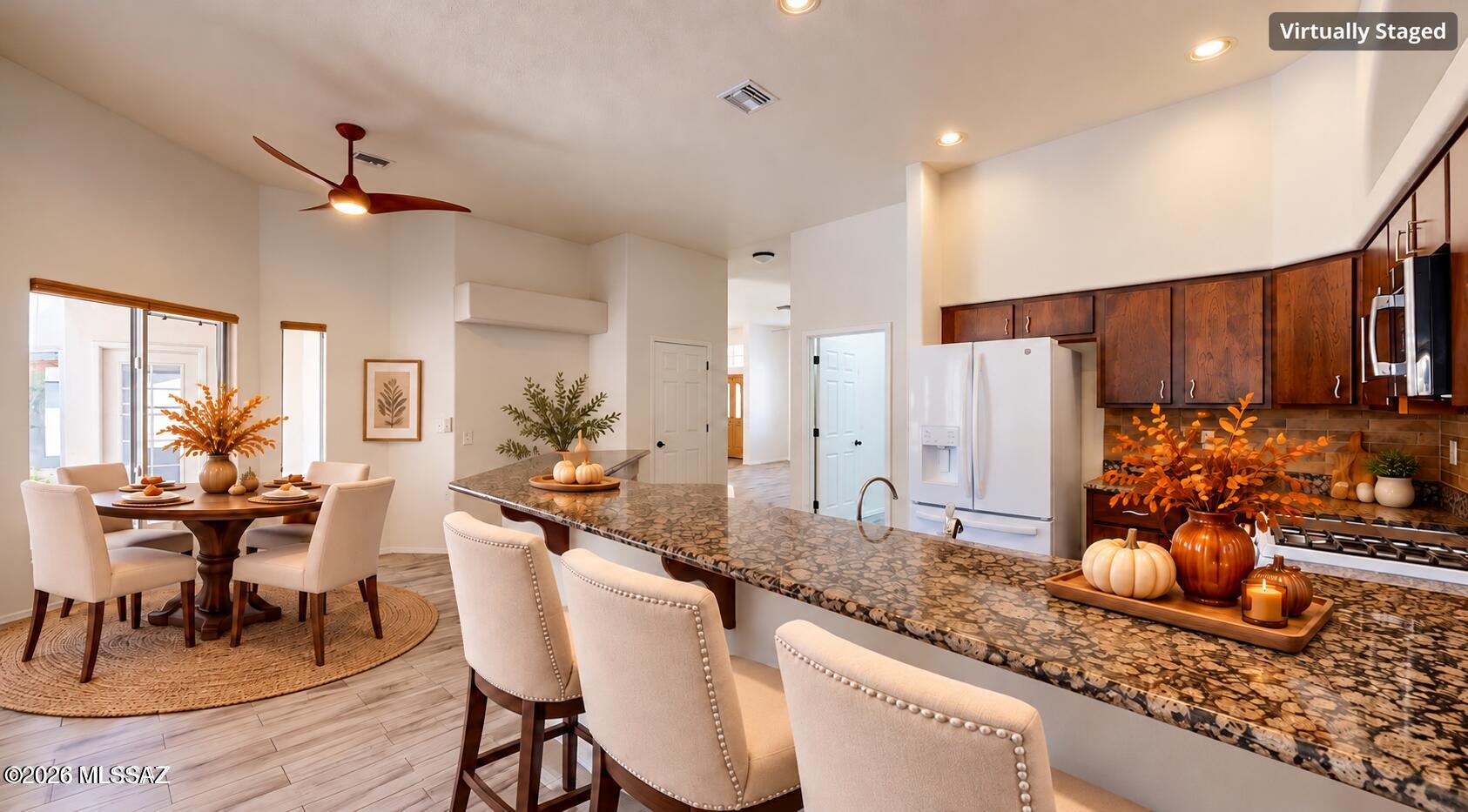 Move-in ready in the heart of Oro Valley! Beautiful 4-bedroom, 3-bath home offering 2,293 sq. ft., a desirable split-bedroom floor plan with 2 primary suites, including a mother-in-law suite layout, and spacious 3-car garage. Bright open-concept kitchen with granite countertops flows into the family room, plus a separate living area for gathering and entertaining. High ceilings, built-in niches, great lighting and lots of windows throughout create a bright, open feel. Spacious primary suite features a large walk-in shower, separate tub and dual vanity. Updates include new tile flooring throughout, new roof and fresh exterior paint. Enjoy beautiful mountain views, natural landscaping, mature fruit trees and a covered patio. Located in Rancho Vistoso near Oro Valley Marketplace.