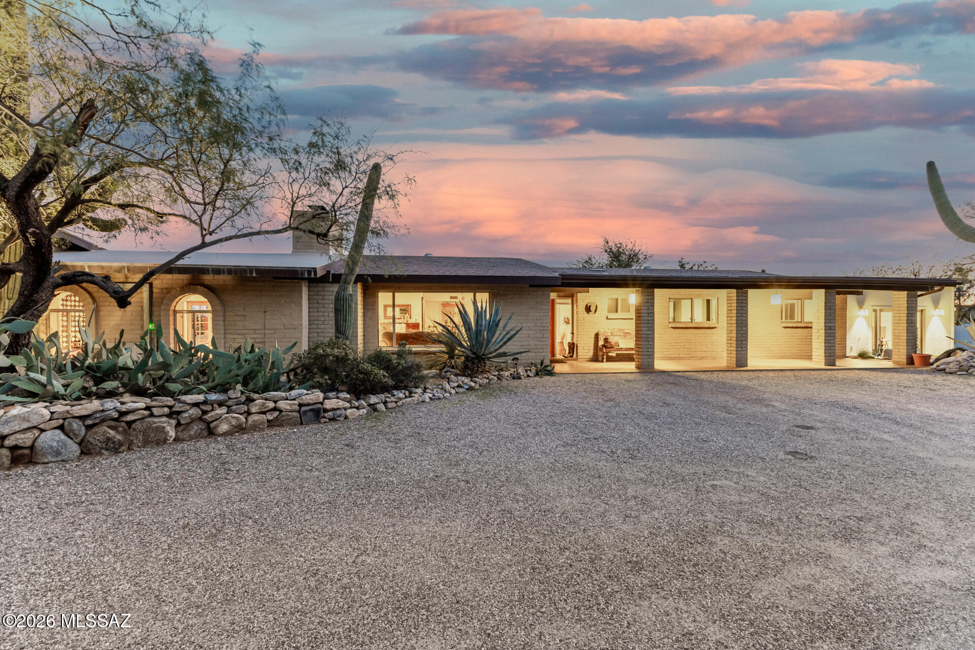 Back on the market with over $26,000 in recent improvements (seller is offering $2,000 in credit for paint), this home truly feels like an oasis in the desert. Enjoy the tranquility and beauty of the Catalina Foothills with mountain views and city light views from the backyard garden or the sparkling salt-water pool. The main home features a spacious primary suite, two guest rooms and southwest themed guest bathroom, a formal dining room, beautiful kitchen with quartz countertops and glass tile backsplash, office, and a great room with a beehive fireplace & a spectacular mountain view. The attached casita suite has a wood fireplace, full bathroom, and is complete with a wet bar. The 2-car garage has ample storage and a workshop. Detached art studio has mini-split, lighting, & plumbing. Recent Work Done: Eaves/Fascia repaired and painted. GFCI outlets throughout home. Gas lines recertified. New sewer line. New salt cell for pool and recent tile clean and service. HVAC and furnace recently (and regularly) serviced.