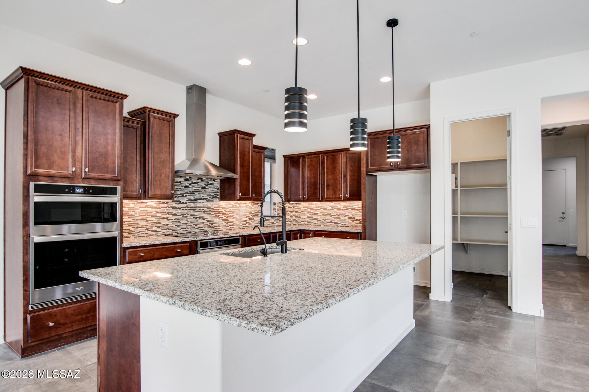 Exceptional contemporary residence in sought-after Lazy K Bar Ranch. This 4 bedroom and teen/game room, 2.5 bathroom home offers a 3 car garage, bonus room, and owned solar, all set against breathtaking forever mountain views with no rear neighbors—backing to natural preserve land.  Owned solar provides long-term efficiency and reduced utility expenses. Enjoy the serenity of this high end gated community with a nearby quiet park. Outdoor living shines with professionally designed landscaping, pavers, built-in BBQ, fire pit, and hot tub that conveys. Generous laundry room with cabinetry and storage and an oversized walk-in closet complete this impressive home.