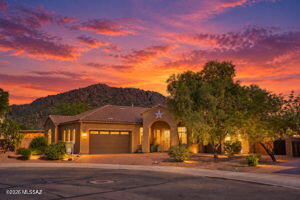 Beautifully upgraded former model home on the biggest and best lot in Saguaro Bloom, with no rear neighbors and breathtaking mountain views! This 4-bedroom, 3-bath home features a 3-car garage, and gourmet kitchen with an oversized granite island. Enjoy your private backyard oasis with a heated saltwater pool and spa, plus over $100,000 in recent improvements! Additional upgrades include new paver sidewalks, professional landscaping, an elegant wrought-iron gate, OWNED SOLAR, EV charger, extra 220V outlet, and mini-split in the third garage bay. Saguaro Bloom offers parks, a community center with gym, zero-entry pool, and splash pad. Near the Loop Trail, featuring 150+ miles of biking paths throughout Marana, Tucson, and Oro Valley. A truly exceptional Arizona lifestyle!