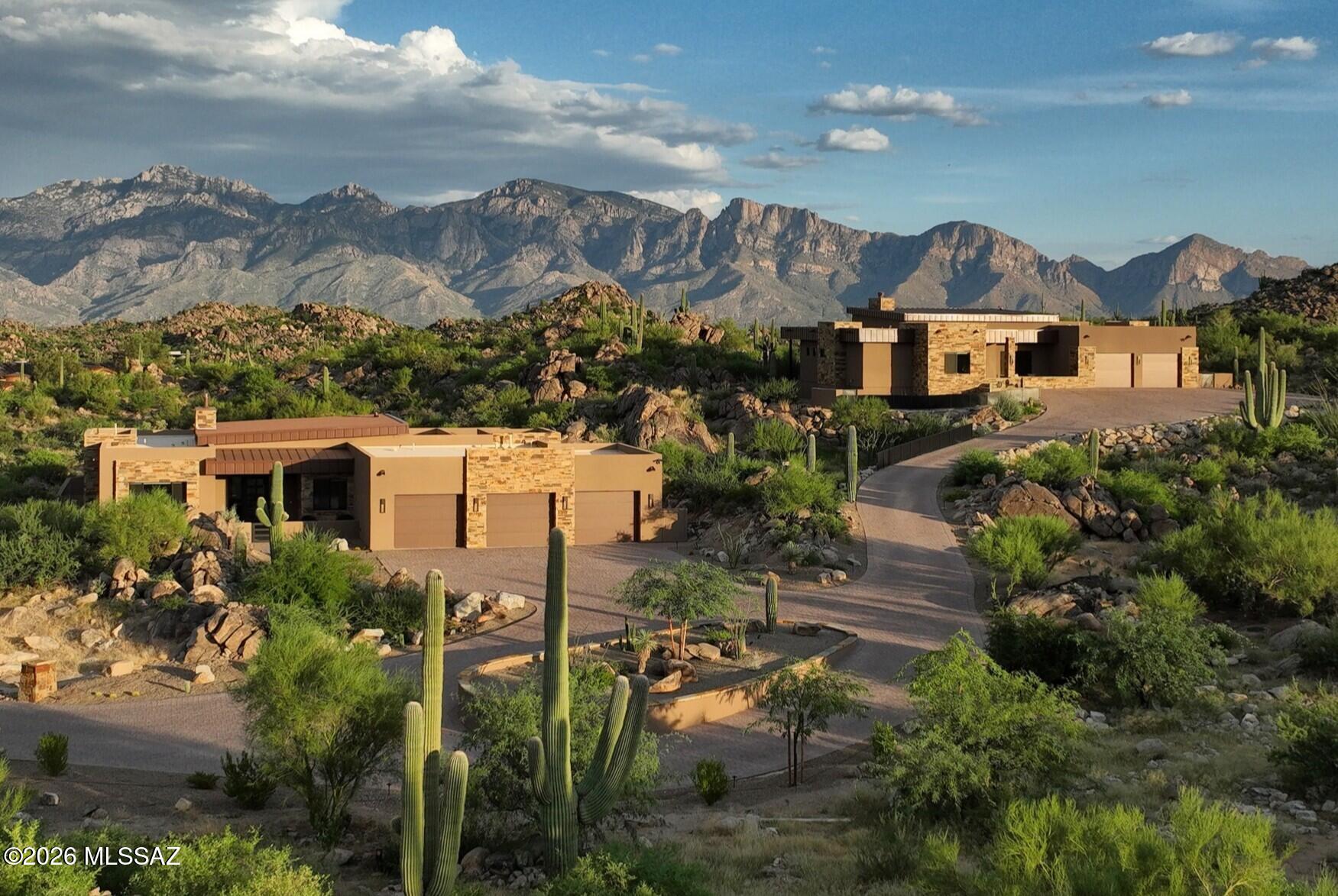 A truly unique opportunity to own a fabulous, recently built, 3,263 sq ft home, along with a spectacular 2,372 sq ft guest home situated on one of the absolutely best lots in Stone Canyon just off the #8 green. The 2.75 acre lot is actually two lots that were combined and is among the highest in elevation in all of Stone Canyon w/ truly panoramic views in every direction, including the Catalina & Tortolita mountains, massive boulders and close-up rock formations, huge saguaros, and offering unparallelled privacy. In total, there are 7 bedrooms, an office, bonus room, 7 bathrooms, garage space for 5 cars, 2 complete kitchens featuring Subzero & Wolf appliances, butler's pantry, 2 great rooms, amazing pool/spa, 2 fire pits, and 2 roof top decks. Please contact agent for complete details.