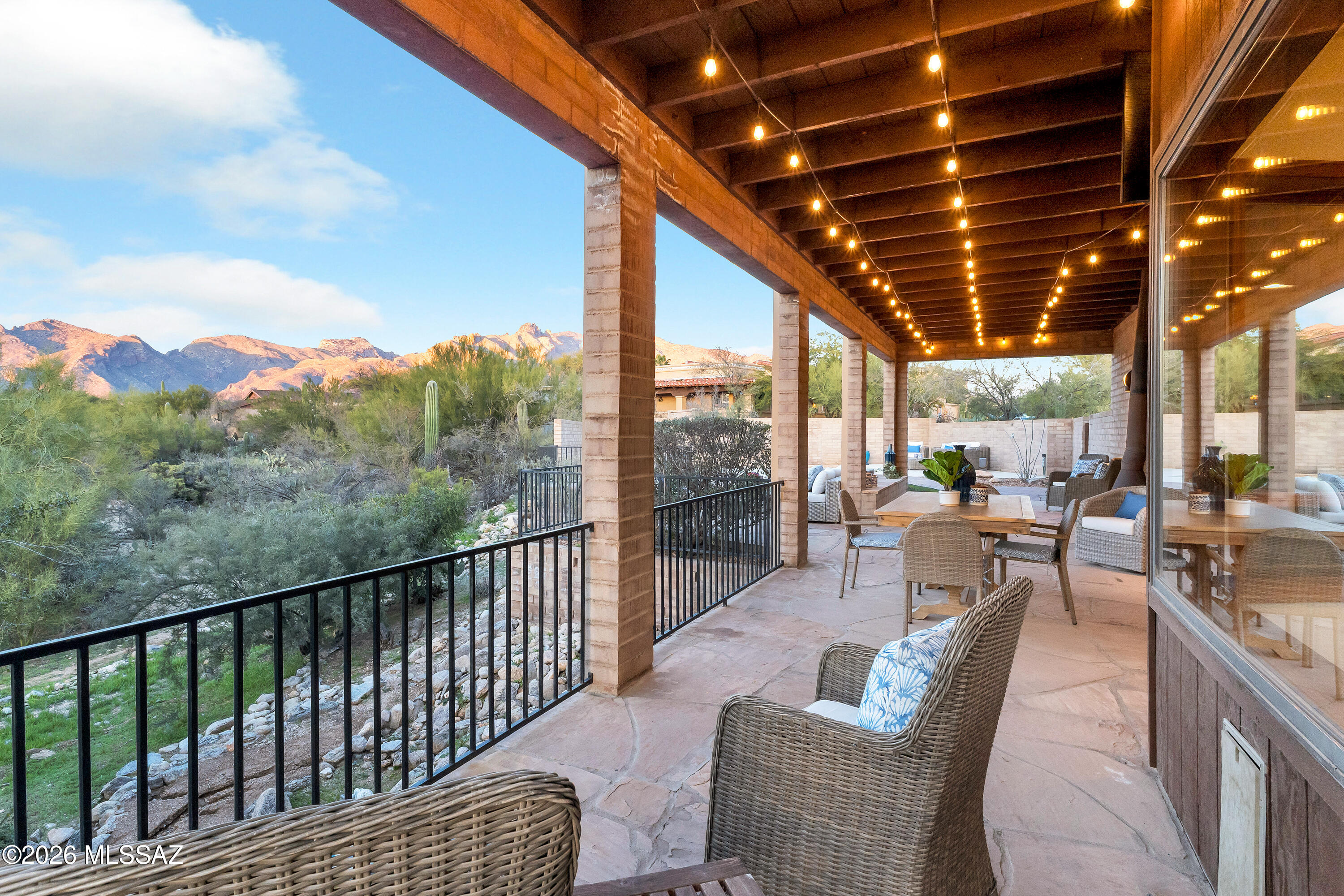 Set on one of the most private and coveted lots in Shadow Hills, this exceptional Foothills residence is a rare expression of refined desert luxury, timeless construction, and breathtaking natural beauty. Surrounded by lush, mature landscaping and exotic cacti, the property offers unparalleled privacy with mesmerizing Catalina Mountain views and unforgettable sunsets that paint the sky each evening. Spanning approximately 3,727 square feet, this impeccably maintained four-bedroom plus den/office, three-bath home features a thoughtfully designed split-bedroom floor plan that balances comfort, functionality, and elegance. A grand interior and exterior entryway welcomes you into light-filled living spaces accented by high ceilings, solid masonry construction, wood-cased and trimmed windows, and no carpet throughout, creating a clean, elevated aesthetic.

The primary suite is a true sanctuaryexceptionally spacious, complete with his-and-hers walk-in closets with custom built-ins and a spa-inspired bath featuring a steam shower that delivers a resort-level experience at home.

Designed for both daily living and entertaining, the chef's kitchen is appointed with granite countertops, Sub-Zero refrigerator, dual full-size wall ovens, a gas cooktop, premium wood cabinetry, and a charming breakfast nook, complemented by a formal dining room and a sophisticated living room with fireplace.

Step outside to a private entertainer's backyardan oasis framed by Sonoran Desert beautyoffering a sparkling swimming pool, outdoor fireplace, built-in TV, and multiple areas for lounging and entertaining, all set against sweeping mountain and sunset views.

Additional highlights include:
" Oversized three-car garage
" Horseshoe paver driveway with ample guest parking
" Abundant storage and closet space throughout
" Low-care desert landscaping
" Brand-new 17 SEER split HVAC system with Wi-Fi-enabled thermostat
" Quiet, walkable, and bike-friendly neighborhood

This is a rare opportunity to own a private, view-oriented estate in one of the Foothills' most sought-after enclaveswhere luxury, craftsmanship, and the Sonoran Desert lifestyle converge.