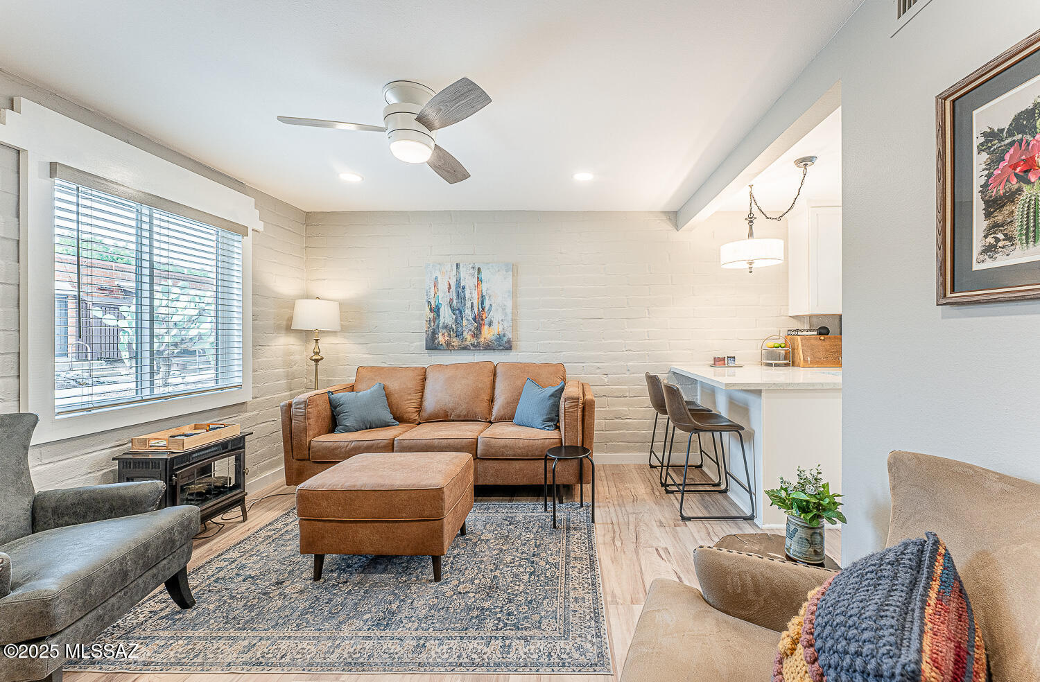 This completely remodeled 2 bedroom Villa is Located in Green Valley Villas East, a 55+ community that was awarded The National Heritage Award and is known for offering low-maintenance, active adult living with comprehensive HOA services. This Villa comes partially furnished and has been completely remodeled with quality finishes throughout. The redesigned kitchen includes upgraded cabinetry, stunning quartz countertops with subway tile backsplash, and new stainless appliances including a dishwasher. The expanded counter space with a peninsula makes this kitchen ideal for both everyday living and entertaining. The remodeled bathroom has a walk-in shower, new vanity and fixtures. Fresh interior paint and luxury vinyl plank flooring throughout, updated lighting, and new windows. Ventless All-in-One Washer Dryer Combo installed in the guest bedroom closet for added convenience. Additional upgrades include fiberglass solid-core doors at the front and back entrances, keyless entry and retractable screen door; upgraded electrical with a new panel and GFCI outlets. An electrical outlet in the second bedroom closet even allows for the potential installation of a ventless washer/dryer unit. The HOA fee provides exceptional value, covering all exterior landscaping, building maintenance of the roof, furnace, A/C, and water heater. Water, sewer, and garbage pickup is free. These HOA services allow for true low-maintenance living. This means time outside enjoying the front patio, birdwatching and sunsets, and walks in the beautiful desert landscape of this historic neighborhood. Beyond the neighborhood there is great walking, hiking and biking trails plus Green Valley Recreation offers world class amenities, fitness centers and facilities.