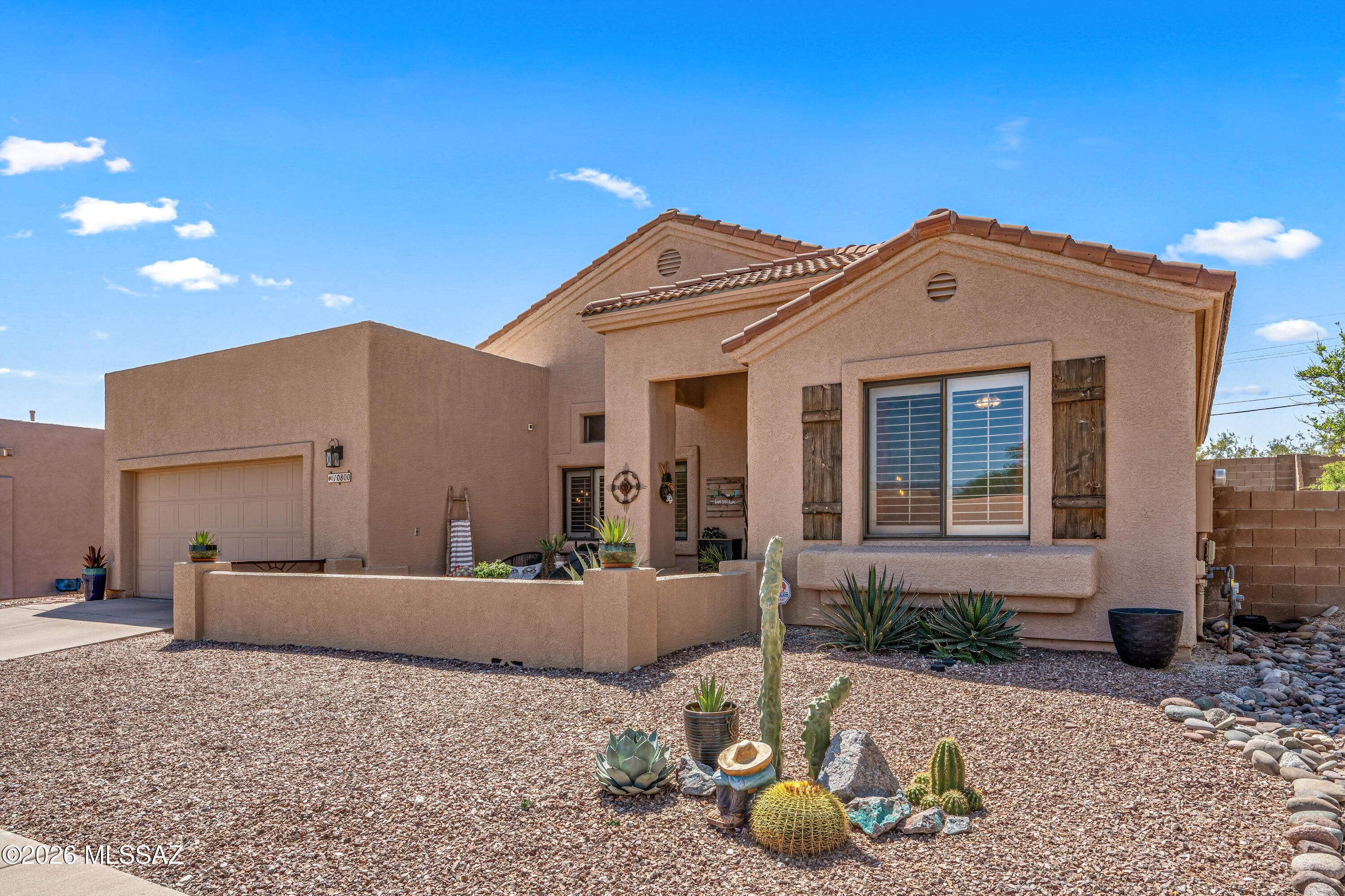 Professionally landscaped backyard offers  tranquility and privacy. Practice your putts in the backyard on the putting green.  A charming front courtyard with a custom privacy wall keeps out desert visitors while welcoming neighborhood visitors! This home is on a quiet cul de sac with no homes behind the property. The floor plan offers a private split bedroom plan perfect for separating the other bedrooms for visitors or working at home. A soaring cathedral ceiling invites you into the living room and beyond where a family room could double as a large eating area. This home is great for entertaining with a yard that offers easy care in a sought after neighborhood.