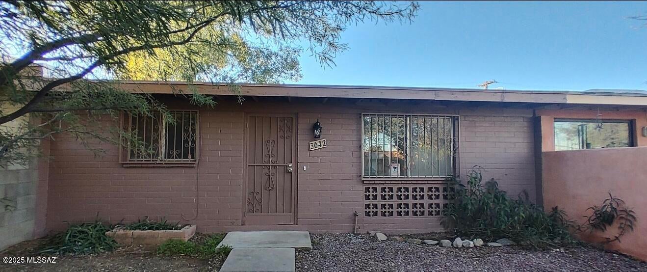 Adorable town home in the most convenient central location! Close to Park Mall, Reid Park, restaurants and shopping! Less than 10 minutes to the U of A, DMAFB and downtown!! new roof installed 2025. This home features 2 spacious bedrooms with ceiling fans, 1 full updated bath with vanity, large living room with ceiling fan, darling kitchen with plenty of room for dining, lighting, cabinets, countertops and newer appliances! Outside is a BIG back yard with covered patio, extra slab and storage that includes washer and dryer hookup. Natural light throughout this home, fresh paint, , and all tile!! NO HOA! Neighborhood is active and friendly, on the bus line, minutes to multiple neighborhood parks and features an urban farm! Come make this your new home today!!