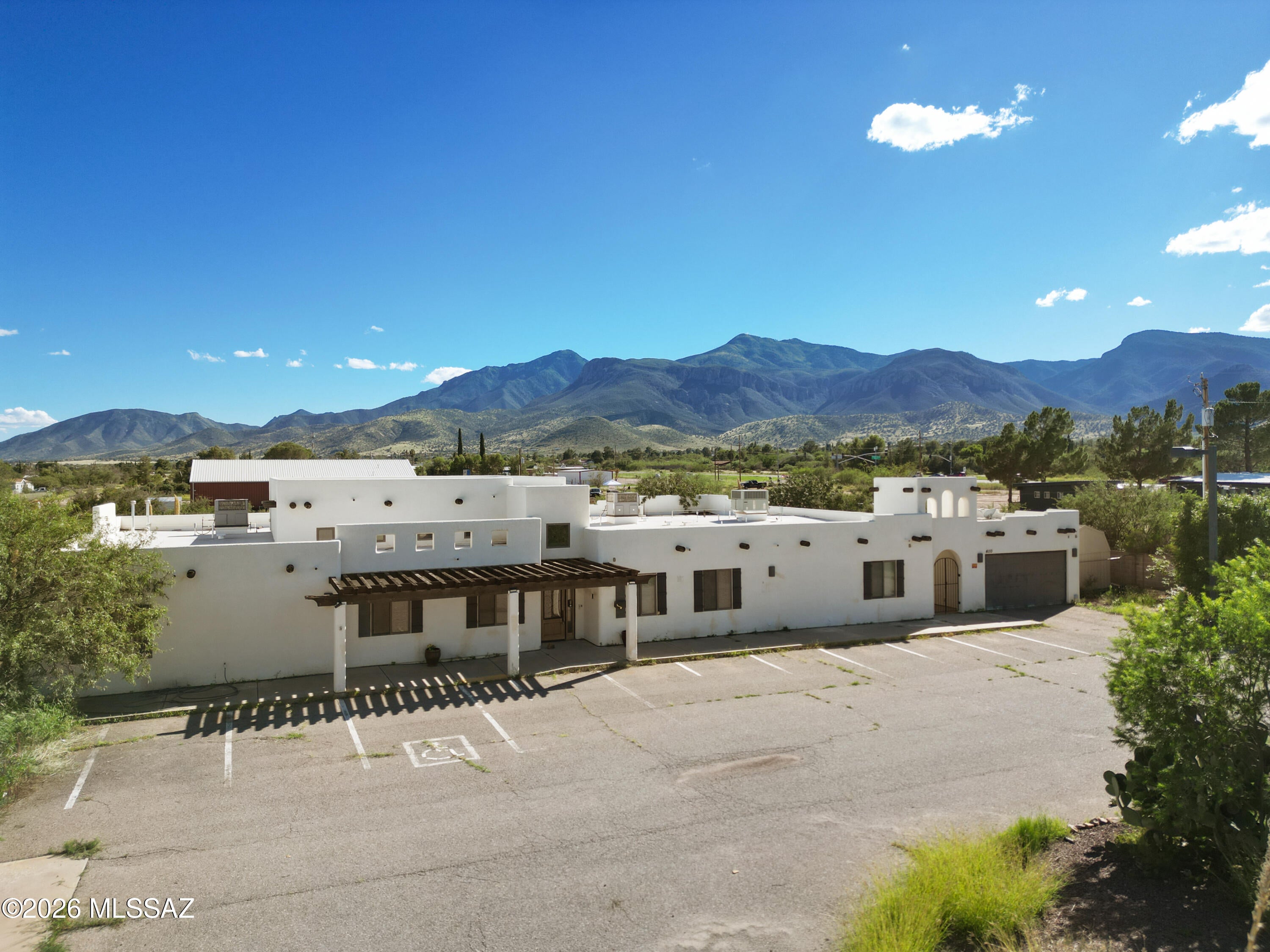 Discover a unique opportunity in Sierra Vista with over 6,900 square feet of improvements on approximately 2.3 acres. Previously configured for assisted living, this property offers an uncommon layout featuring approximately 15 private locking bedrooms, each with its own bathroom, along with a spacious great room, kitchen, office, laundry room, two-car garage, and large driveway/parking area. The existing configuration provides an extensive infrastructure package that could be particularly appealing to assisted-living, senior-care, healthcare, education, office space, religious use, or other specialized users, potentially saving significant time and expense compared with creating a similar facility from an ordinary commercial shell. The large common areas, private rooms and bathrooms, office and laundry facilities, acreage, and parking also provide flexibility for other potential uses, subject to zoning, building, fire, licensing, occupancy, and other applicable requirements. The property is currently vacant, offering a new owner the opportunity to bring their own vision to this substantial Sierra Vista property. Whether you're looking for an existing special-purpose configuration or exploring an alternative use, the combination of size, acreage, and extensive existing improvements makes this a property worth exploring.