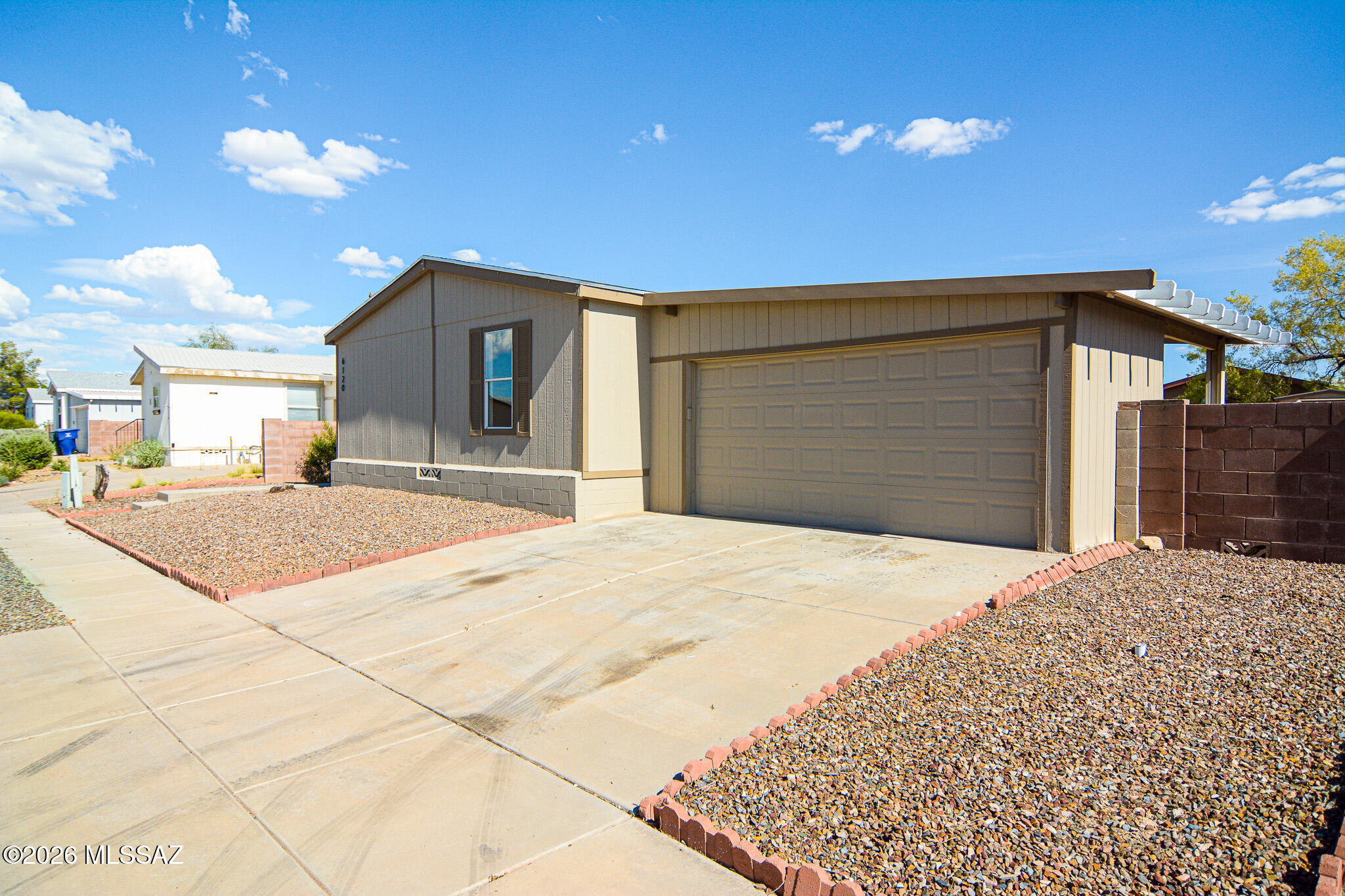 Beautifully remodeled Manufactured home. Located in a convenient East Tucson location. Minutes from the I-10. Rich wood look luxury vinyl plank flooring. Electric insert fireplace in living room. New kitchen features SS appliances. New upgraded carpet and padding in one bedroom. New interior paint. Spacious owner's suite. Large fenced yard. Two carports with garage door for security. Storage shed. Gated community. This home shows beautifully.