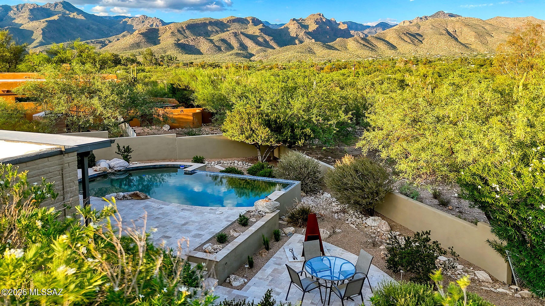 A Rare Opportunity-Beauiful East Facing Patio Views of Rincons+Catalinas-Updated Interiors-Inviting Salt Water Pool surrounded by light Travertine Stone Tile-One Level,NO Interior Steps-Cimarron Circle designed Pool,Front and Rear Landscape to be both water efficient and so attractive! Kitchen was recently Upated-Quartz Counters-Upscale GE Appliances,SS Kraus Sink-Breakfast Nook has built in Seating and Table with same Quartz top. Both Baths have been remodeled W/Undermount Sinks,Quartz Counters,Clear Glass surrounds.- LR/Flex Rm has paned French doors to both charming entry+kitchen ,raised hearth FP graces corner of this room w/many uses. Flooring either Stone or new LVP.Fresh Interior+Exterior Paint-'26 H2O Heater-'22  AC/Furn--Great Taste-Stunning-Sellers related to 1 LA-See Doc Tab Home sits above the North end of Canyon Ranch-(not visible from the patio or home). New owners can access the Canyon Ranch Walking Loop by path adjacent to this home(just south of it, or, right).  The Ranch encourages neighbors to walk this 2 miles loop--walkers are asked to "stay on the loop, please".  The Wes Miller Park is a quick walk-5 minutes-to Sabino Creek from this home. There are picnic benches, trees, lots of birds and wildlife.  The HOA is Voluntary, if you care to be part of it for $45.00 per year, you will be given access to this private part of Tucson which is another aspect that makes this home special.  The sellers lived here for 25 years-raised their 2 children. They put in the pool, irrigation, stone pool decking(stays totally cool to touch/feet) and landscape, too. Cimarron Circle was their contractor for all of this work.  Cervantes Roofing re-roofed the home in 2017 and have maintained it ever since.  The last re-coating was also done by Cervantes in 2025. There is a large storage area off of the garage which had an AC unit in it at one time. owners removed it and used it only as storage, the floor heaters are as-is in this store room.  There is a cedar lined closet in the garage as well.  Lots of happy times in this home, it is a rare find, indeed!
