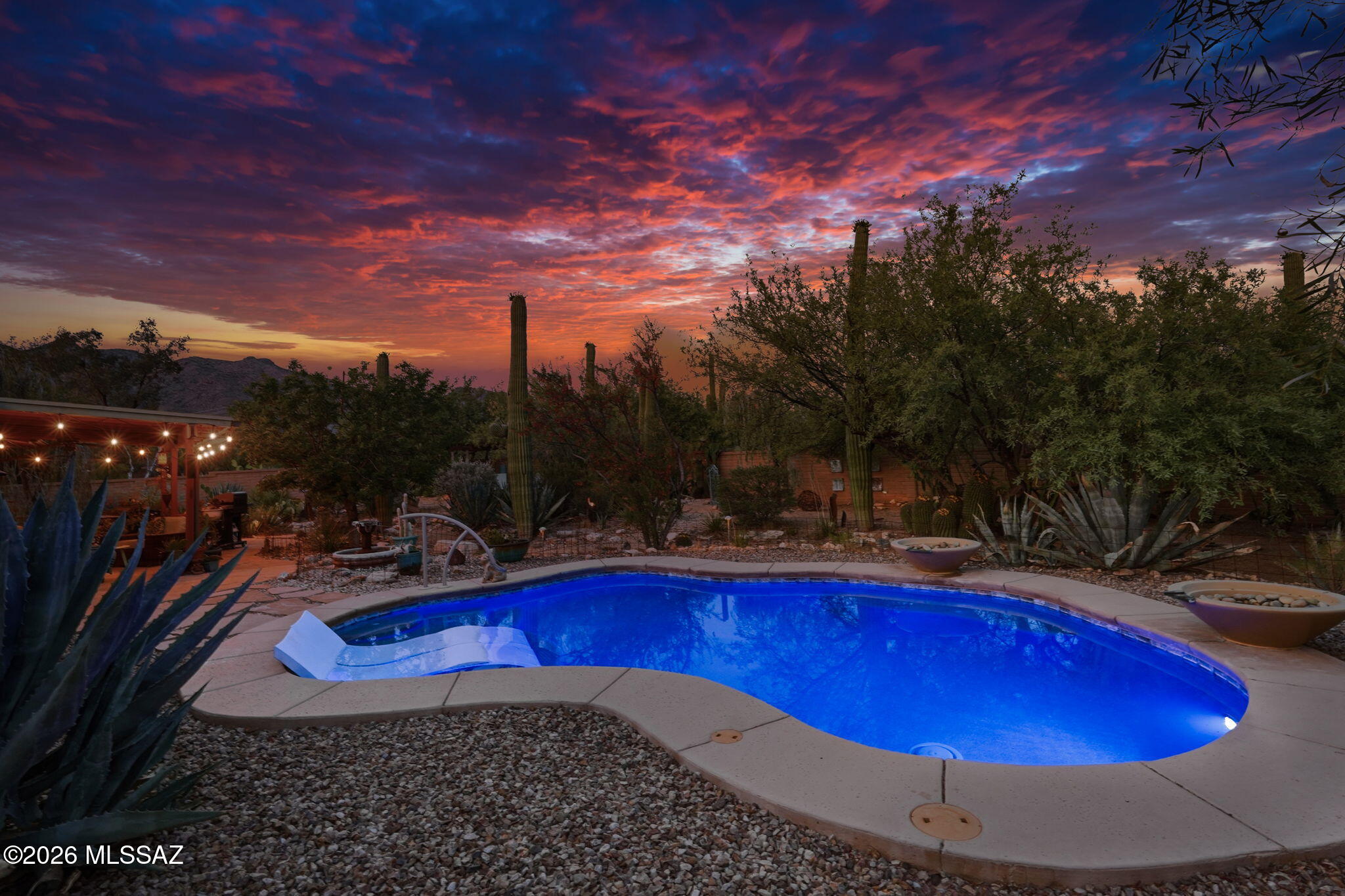Nestled on a quiet, saguaro studded corner lot is this beautifully maintained home with mountain views from the front and back.  Updated kitchen and baths blend style and functionality. 3BR/2BA floor plan offers formal dining,  family room off the kitchen, and separate living room. Plantation shutters & ceiling fans thru-out. Step outside to a fully enclosed backyard retreat featuring a charming covered patio, ramada, beach-entry pool with seating and water feature, plus ample space for pets and gardening. Designed for both relaxation and entertaining, exceptional outdoor living area offers complete privacy, mature vegetation, and spectacular sunsets. NO carpet, NO HOA and OWNED solar provide added value and efficiency. Pre-listing home inspection is available for added buyer confidence.