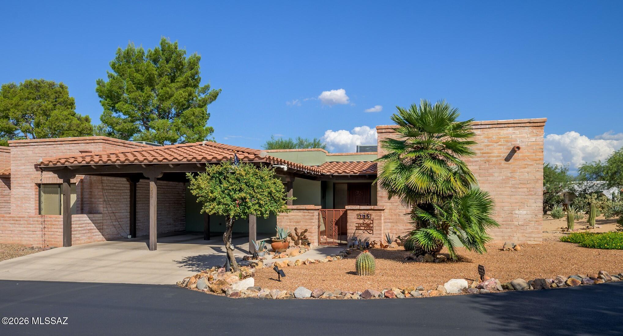 Welcome to a truly exceptional home meticulously designed for those who cherish the tranquility and beauty of the desert. Nestled in a private setting, this completely remodeled abode offers the perfect blend of comfort, style, and connection to nature. From the moment you arrive, the hand-carved solid-wood door, adorned with soft gold accents, creates a warm and inviting atmosphere.  Step inside to discover stunning neutral tile flooring throughout and an airy, serene palette that instantly fosters a sense of harmony. The spacious living area is enhanced by an artistically painted kiva fireplace and large windows that frame picturesque views of the natural desert landscape, infusing the space with light and calm.  Culinary enthusiasts will fall in love with the reimagined kitchen, boasting rich butcher-block countertops, crisp white cabinetry, stainless-steel appliances, and an eye-catching geometric backsplash. A cleverly designed central island serves as both a functional workspace and a cozy setting for casual dining.  The two generously sized bedrooms are complemented by luxurious bathrooms that showcase custom tile showers with stone waterfall accents and dual rainheads, creating a spa-like experience.  A flexible bonus space off the living room awaits your vision--perfect for a home office, hobby area, or gym.  Step outside to the secluded east-facing patio, where you can bask in the tranquility of the stunning desert landscape and majestic mountain vistas. The gentle breeze carries the earthy scent of the surrounding flora, while the warm sun creates a perfect backdrop for moments of relaxation and contemplation.  Notable updates include window replacements, a roof replacement, energy-efficient LED lighting, modern ceiling fans, and a Waterdrop reverse osmosis water purification system.  Centrally located in the center of Green Valley, it is conveniently located near Green Valley Recreation centers and restaurants. Explore this unique community featuring 33 acres of common areas, scenic walking trails, and parks--perfect for active retirees who love nature and outdoor living.