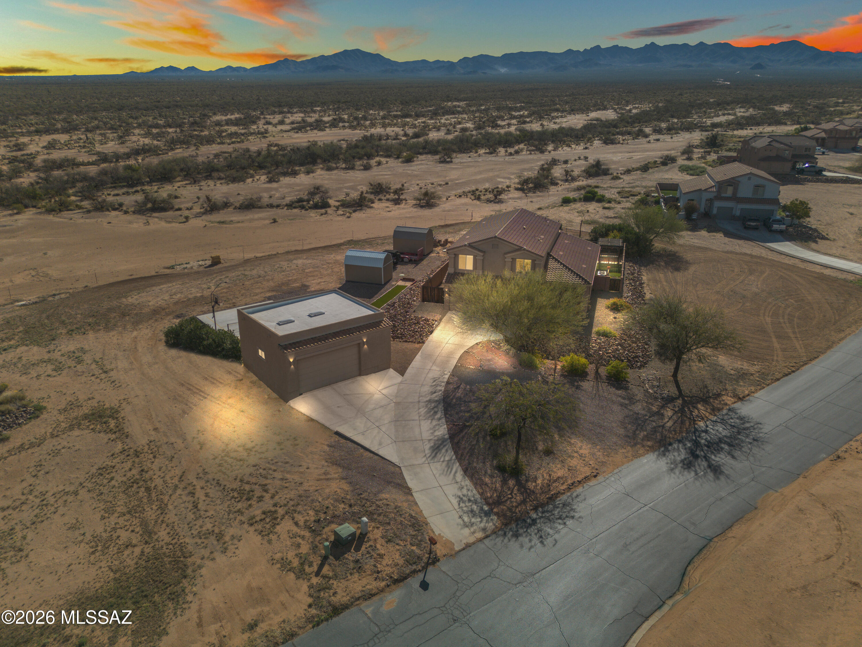 If you're looking for acreage, mountain views, and room for all your toys, this Sahuarita Highlands property has it! Offering 3,185 sq. ft., 5 bedrooms and 3 full baths, there's plenty of space inside and out. The incredible 900 sq. ft. heated and cooled detached shop is perfect for cars, hobbies, a workshop, home gym, extra storage, or whatever you need the space for. There's also a 3-car attached garage and RV parking.
Inside, soaring two-story ceilings give the home a bright, open feel. The front living and dining area offers flexible space for entertaining, a second living room, play area, or home office. The kitchen features dark wood cabinetry, granite countertops, a large center island and electric range, all opening to the great room so everyone stays connected Even better, enjoy beautiful mountain views right from the kitchen window. A main-floor bedroom and full bath are ideal for guests or multigenerational living, with the laundry room conveniently located nearby. Upstairs you'll find four additional bedrooms, including a spacious primary suite with double-door entry and its own private balcony overlooking the mountains. Outside is all about enjoying Arizona living with a 22' x 22' covered patio, turf, panoramic mountain views, pickleball/basketball court and horseshoe area. With plenty of room for RVs, trailers and outdoor toys, this is a property made for anyone who wants more space to live, play, entertain and enjoy their hobbies.