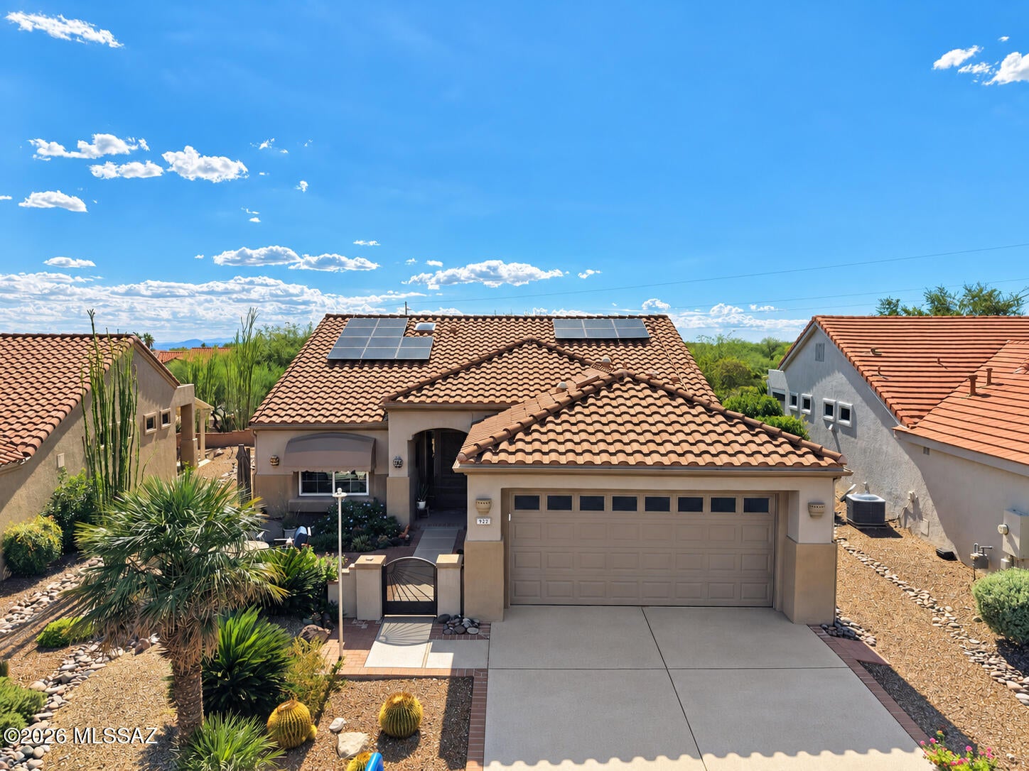 Welcome to this beautifully updated and maintained 2BD/2BA home with den in desirable Sun City Oro Valley! Offering an open floor plan with great flow, this home combines comfortable living with thoughtful updates and features. Owned solar helps keep utility costs low, while a gated front courtyard welcomes you into the home. Beautiful mountain views and a beautifully landscaped yard with mature fruit trees create a peaceful outdoor retreat.

The home features tile flooring throughout, including new wood-look porcelain tile in both bedrooms. The updated kitchen and bathrooms, newer refrigerator, updated windows, and dedicated laundry room add to the home's comfort and convenience. The den/office includes a Murphy bed, making it a versatile space for guests, an office, or hobbies. Additional recent updates include added storage and workspace in the garage, new steel garage door with WiFi-enabled LiftMaster opener, updated irrigation, new patio shades, a new water heater, and a new GE microwave.

A standout feature is the 11.4 kW owned solar PV system, installed in 2022, providing energy efficiency and potential savings on electricity. Enjoy all that Sun City Oro Valley has to offer, including its beautiful golf courses, fitness and recreation facilities, pools, tennis and pickleball, clubs, classes, and vibrant social community. This home offers comfort, versatility, energy efficiency, and peace of mind in a wonderful active-adult community.