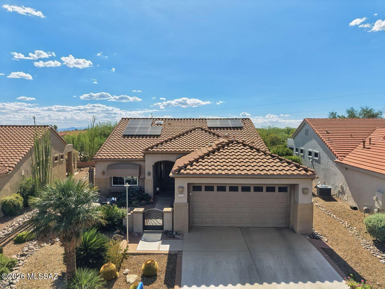 Welcome to this beautifully updated and maintained 2BD/2BA home with den in desirable Sun City Oro Valley! Offering an open floor plan with great flow, this home combines comfortable living with thoughtful updates and features. Owned solar helps keep utility costs low, while a gated front courtyard welcomes you into the home. Beautiful mountain views and a beautifully landscaped yard with mature fruit trees create a peaceful outdoor retreat.

The home features tile flooring throughout, including new wood-look porcelain tile in both bedrooms. The updated kitchen and bathrooms, newer refrigerator, updated windows, and dedicated laundry room add to the home's comfort and convenience. The den/office includes a Murphy bed, making it a versatile space for guests, an office, or hobbies. Additional recent updates include added storage and workspace in the garage, new steel garage door with WiFi-enabled LiftMaster opener, updated irrigation, new patio shades, a new water heater, and a new GE microwave.

A standout feature is the 11.4 kW owned solar PV system, installed in 2022, providing energy efficiency and potential savings on electricity. Enjoy all that Sun City Oro Valley has to offer, including its beautiful golf courses, fitness and recreation facilities, pools, tennis and pickleball, clubs, classes, and vibrant social community. This home offers comfort, versatility, energy efficiency, and peace of mind in a wonderful active-adult community.