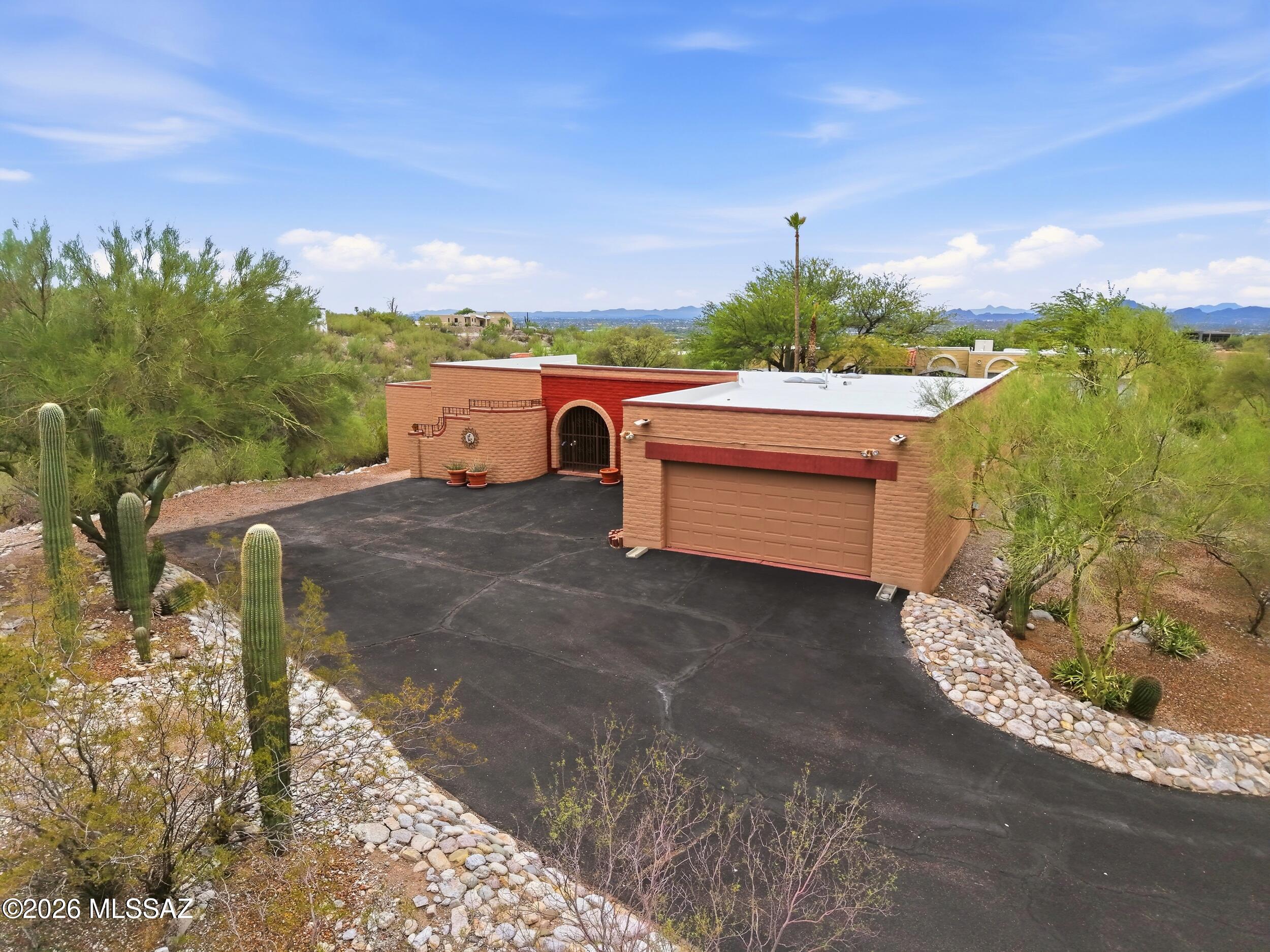 $575-$600K. Welcome Home to the Top of the Hill in Sunrise Presidio Village. This 3 bedroom, 2 bathroom territorial home features architectural elements that are reflective of the Southwest region's history. The home is perched high up in the foothills with sweeping mountain and desert landscape views that can be enjoyed from both inside the home or out by the freshly replastered pool. Step inside to the warmth of authentic saltillo tiles, thick premium carpet, warm custom paint, exposed wood beams and more. The kitchen is updated with full overlay wood cabinetry, stainless steel appliances and a glass tile backsplash. The owner's suite is spacious, boasts an en-suite bathroom with a dual vanity and Roman style shower with dual showerheads. Enjoy this well-maintained home. Come. See. Stay!