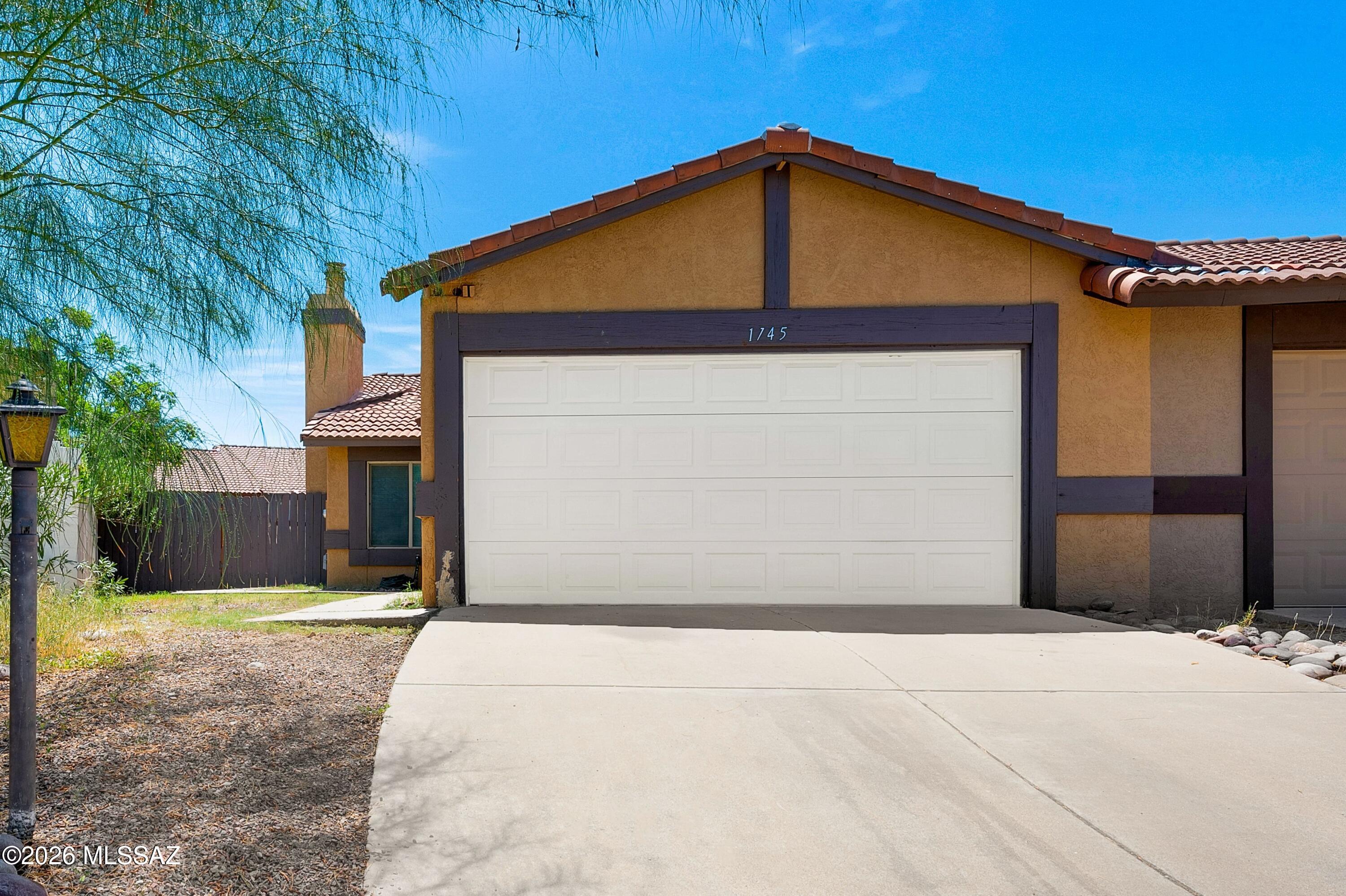 Welcome to this charming townhome ideally situated near the University of Arizona, I-10, parks, restaurants, grocery stores, and the El Rio Neighborhood Center, offering easy access to many of Tucson's best amenities. Inside, tile and wood flooring flow throughout the living spaces, while a cozy fireplace creates a warm and inviting focal point in the living room. The kitchen features stainless steel appliances, and fresh paint and touches add to the home's appeal. Step outside to the large backyard, which offers plenty of space for relaxing, entertaining, gardening, or enjoying Tucson's beautiful weather. This is a great opportunity for anyone looking for comfort, convenience, and accessibility in a central Tucson location.