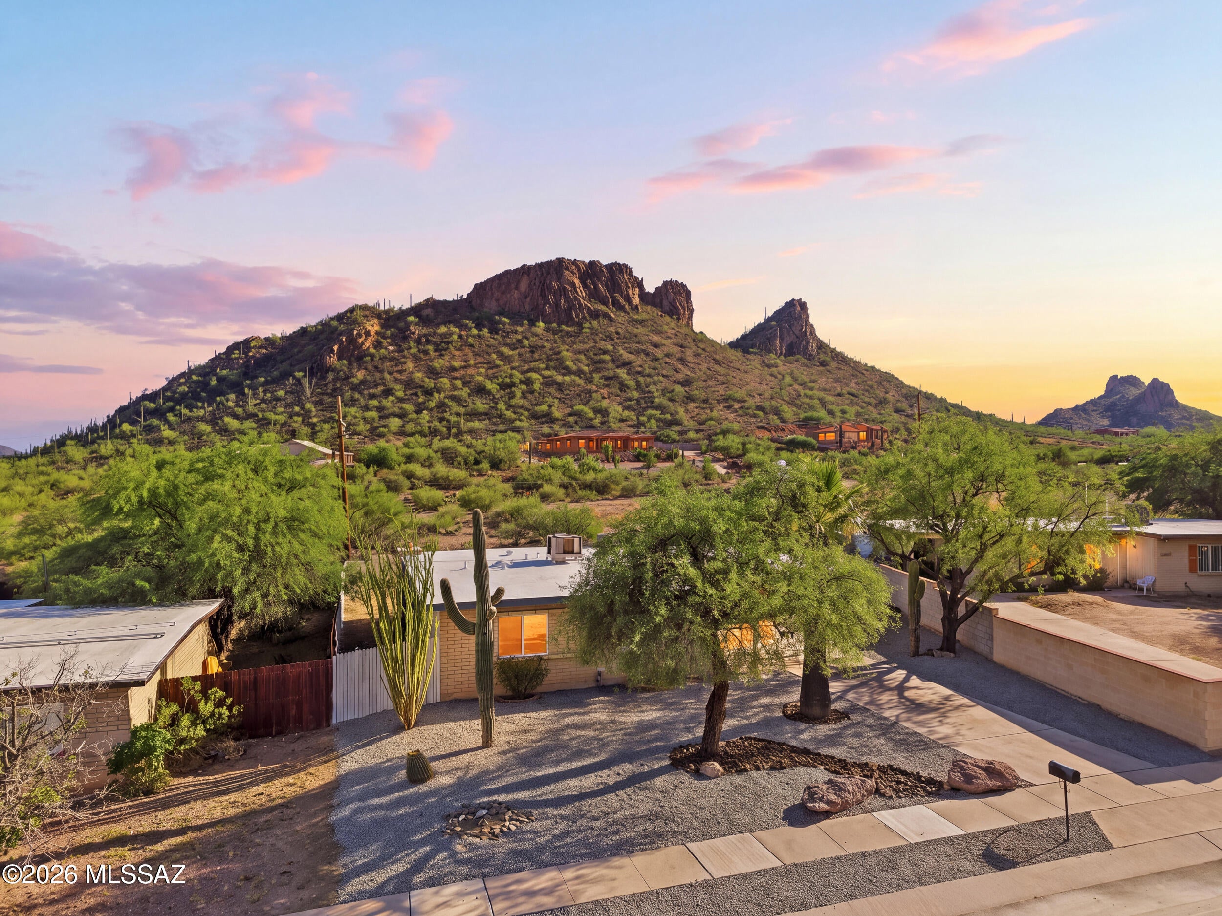 **Range price between 320k-330k. Concessions offered** 
Welcome home to your private desert retreat where modern elegance meets Tucson's natural allure. With breathtaking mountain-views and situated at the foot of the mountain!
Featuring a long driveway, manicured landscaping, no HOA, and fresh rustic paint.. this home has it all!
Inside, you'll find upgraded kitchen cabinets with en eat-in island, quartz countertops, sparkling marble back-splash and stainless-steel appliances. That Segways into a family room with french doors and a wood burning fireplace where you can cozy up with Loved ones. This home has remote controlled/LED cooling fans throughout, upgraded stone ceramic flooring in all main areas, that engulfed by the warm natural lighting that flows effortlessly through every roo Both bathrooms have been beautifully updated with tile showers, marble accents, and newer fixtures that feel fresh, modern, and refined. Step outside and prepare to fall in love with this backyard that was designed to impress! Wonderfully landscaped with cacti and desert plantings. This hime features a cooled workshop, a dog run, ample porch, and private fencing provides a touch of seclusion, perfect for morning coffee or twilight unwinding. And with those sweeping mountain views wrapping around you, every sunset feels special..
With near proximity to schools, parks, trails, shopping, and dining.
This isn't just a home.. it's an escape, wrapped in comfort, privacy, and desert beauty.
Owner/Agent.