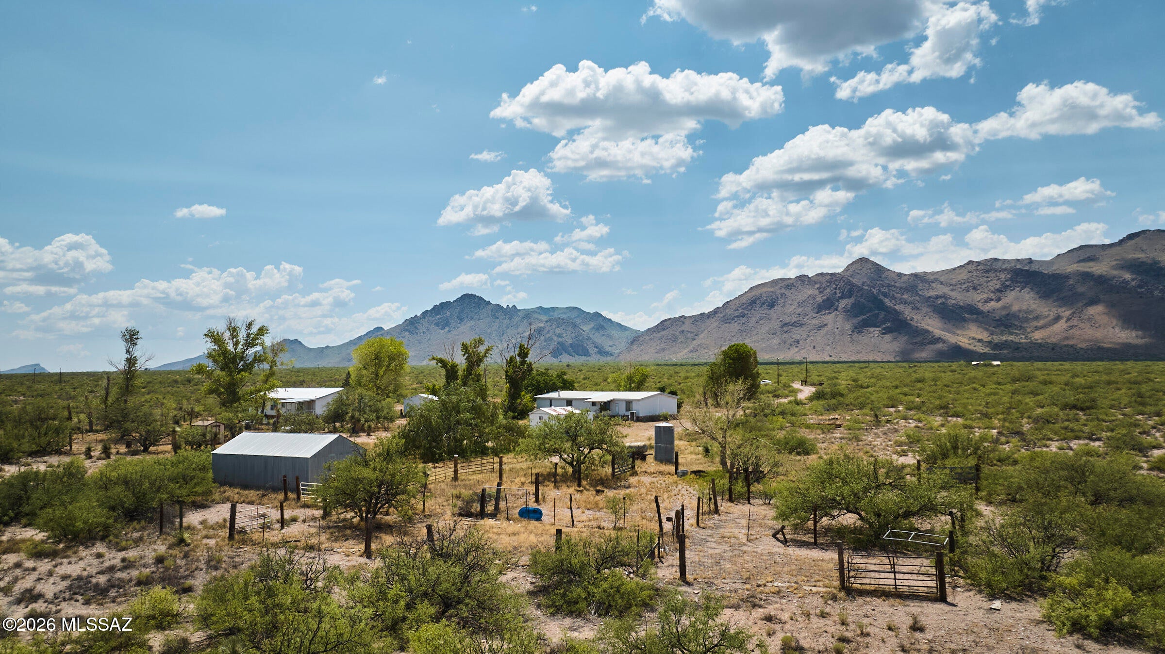 Bring your homestead dreams to life on 228 fully fenced acres spanning 3 parcels! This unique property offers two homes, an excellent option for multi-generational living, extended family, guests, or a rural retreat. Improvements include a 400-ft well, 770 sq ft detached 2-car garage, 197 sq ft ADU with kitchenette and bathroom, and a 528 sq ft barn. With a history of use for sheep, the property is already suited to those dreaming of livestock, gardening, self-sufficiency, Multiple parcels and existing infrastructure offer flexibility for your vision. A rare opportunity to create your own homestead with space for animals, projects, and possibilities!  RU-4 Zoning. 30 minutes from Cave Creek Canyon for world class birding and hiking. Dark night skies and epic mountain views await!
