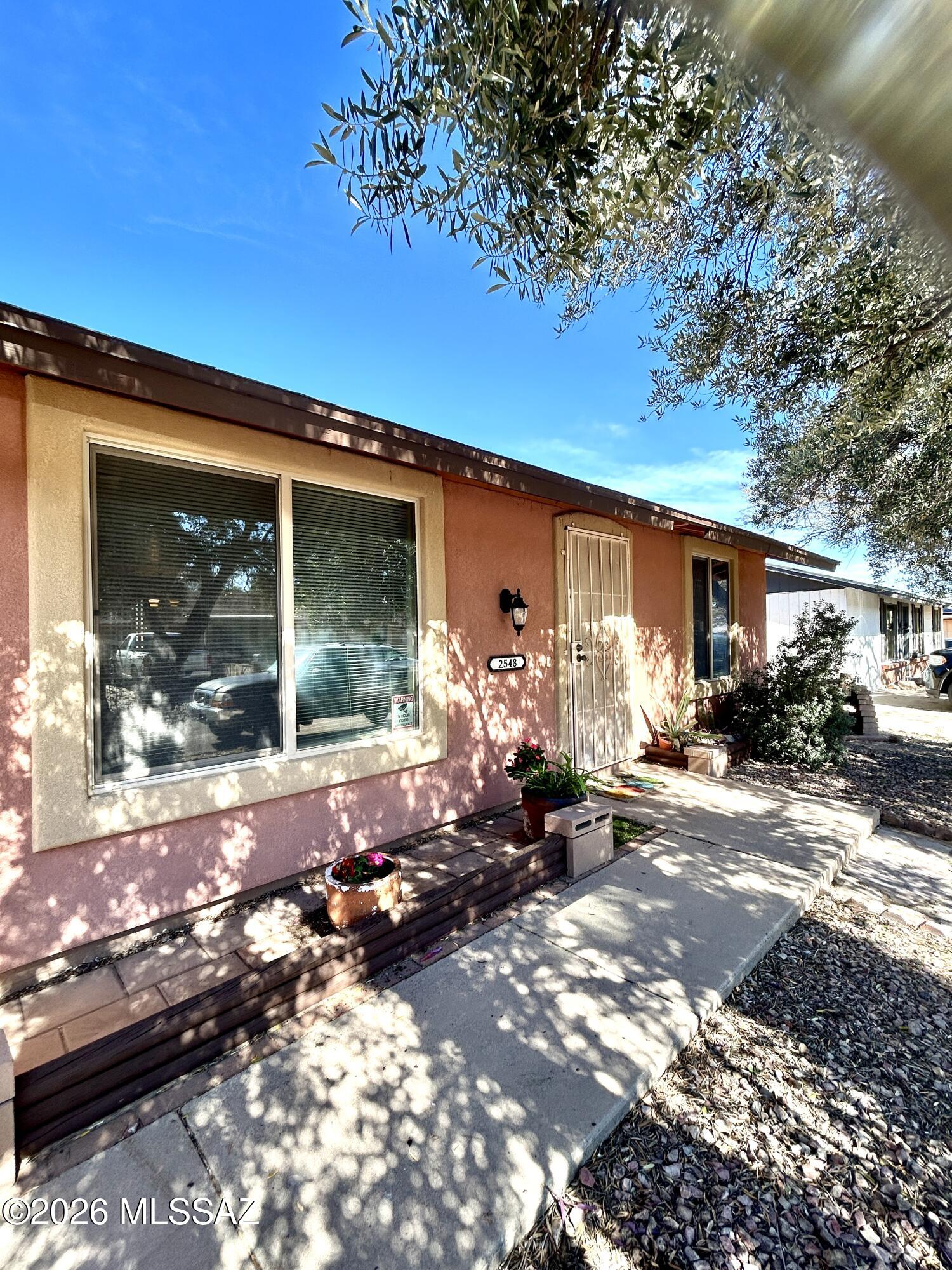 Great location in an established neighborhood. Well maintained full of upgrades 2 bedroom 1 Bath home. Spacious living room area that opens to dining area. Ceramic flooring throughout. Charming kitchen complete with almost new range and refrigerator, nice wood cabinets and granite counter tops. large laundry room next to the kitchen. Beautiful spacious private back yard surrounded with a block wall. includes a covered porch and a storage shed, nice well-built ramada/gazebo with attractive bar. For efficiency house upgraded with almost all dual-pane windows & conveniently installed solar panels (lease) also has been recently covered with thermal texturing.