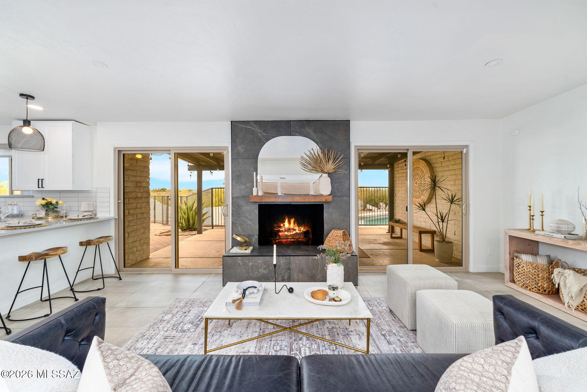 Tucked on a private and elevated lot with sweeping city and mountain views, this beautiful and completely remodeled 4bd/2ba hacienda-style home offers a seamless blend of charm and modern upgrades. Step inside into a peaceful sitting room with picture windows framing mountain views, and a central atrium that fills the home with natural light. With four spacious bedrooms, two beautifully updated bathrooms, a den, and a dining area featuring a custom wet bar, every space has been thoughtfully curated. The kitchen has stylish design choices, with a quartz countertop waterfall peninsula, high-end appliances, and pendant lighting. Outside, a generous sized pavered patio, PebbleTec pool and spa with a brand-new heater offers plenty of space for outdoor living. Enjoy serene mornings and sparkling city lights at night, all from the tranquility of your own retreat. This one-of-a-kind property is a rare blend of nature, luxury, and convenience. Your slice of heaven awaits! Just minutes from beautiful walking and biking paths, Whole Foods, restaurants, and high-end shopping! Roof recoated September, 4 2025!