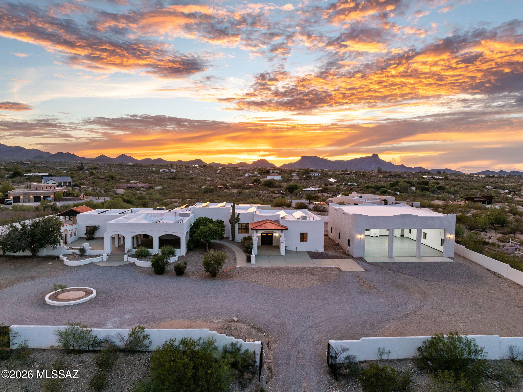 Sprawling 3.45-acre estate offering privacy, stunning mountain views, and exceptional outdoor living. Two gated entrances lead to detached RV garage with room for up to 10 vehicles, a circular driveway, desert landscaping, covered patio, pool, and gazebo. Inside, enjoy soaring ceilings, marble flooring, stylish fixtures, a cozy fireplace, and an inviting open layout. The kitchen features granite counters, custom cabinetry, stainless-steel appliances, stone backsplash, and breakfast bar. Two primary suites each offer private en suite bathrooms with dual vanities, soaking tubs, and spacious showers. Expansive grounds provide plenty of room for entertaining, relaxing, and enjoying breathtaking Arizona sunsets. A rare opportunity to enjoy space, comfort, and desert living. a soaking tub, a raindrop shower, and a large walk-in closet. Imagine enchanting evenings in the backyard, which offers a charming gazebo and a sparkling pool with a diving board for endless summer fun. Make is incredible gem yours today!
