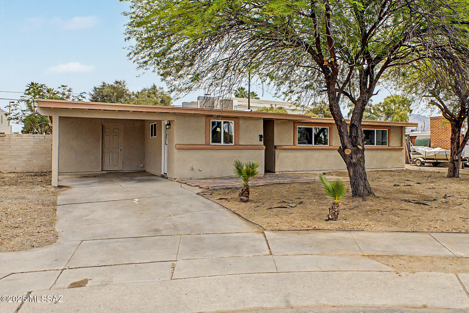 Fantastic opportunity to own this charming 3-bedroom, 2-bath home on a peaceful cul-de-sac! You're greeted by an attached carport and mature trees for natural shade. Inside, the living room has a soothing palette and stylish wood-look flooring. The eat-in kitchen features crisp white cabinetry, laminate counters, and sleek stainless steel appliances for a seamless cooking experience. The main bedroom includes plush carpeting, a private bathroom, and a walk-in closet. Venture out onto the backyard, which offers a covered patio, direct alley access, and a large workshop or extra storage. Conveniently located close to bus stops, restaurants, and shopping options. Don't miss out on this one!