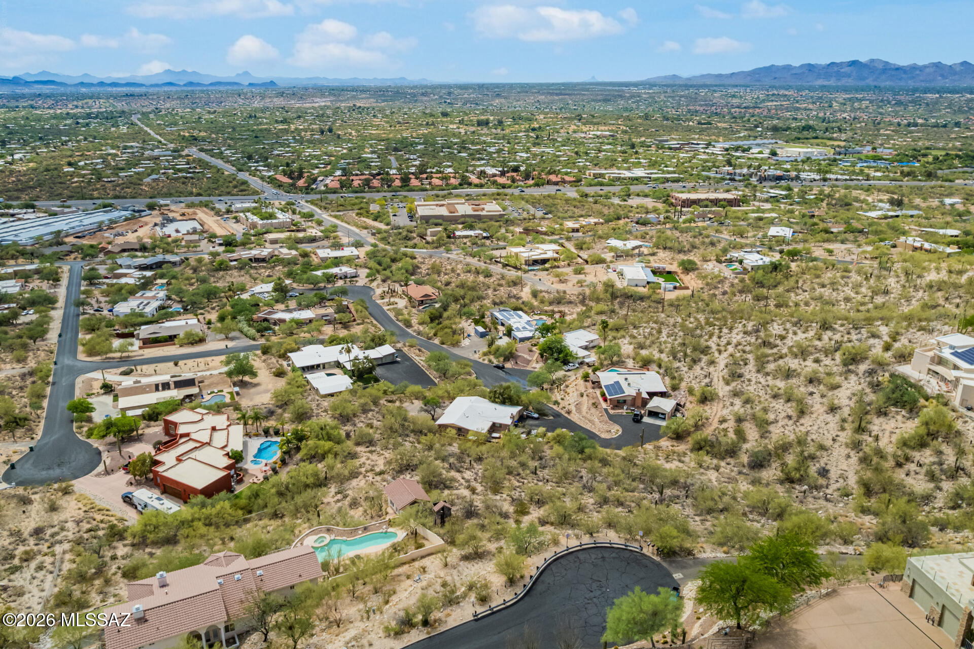 Exceptional opportunity to build your custom dream home in the heart of Oro Valley! Perfectly positioned on an elevated cul-de-sac lot backing to the majestic Santa Catalina Mountains, this stunning .98-acre homesite showcases breathtaking panoramic mountain and sparkling city views. Surrounded by lush native vegetation and tranquil desert beauty, the property offers a serene setting. Enjoy spectacular Arizona sunsets, star-filled skies, and the privacy of an exclusive location, all while being just minutes from Oro Valley's premier shopping, dining, schools, medical facilities, golf courses, hiking trails, and recreational amenities. A rare chance to create the desert retreat you have always envisioned! Hillside/sloping lot.  The Sellers have obtained preliminary architectural work demonstrating potential building design.