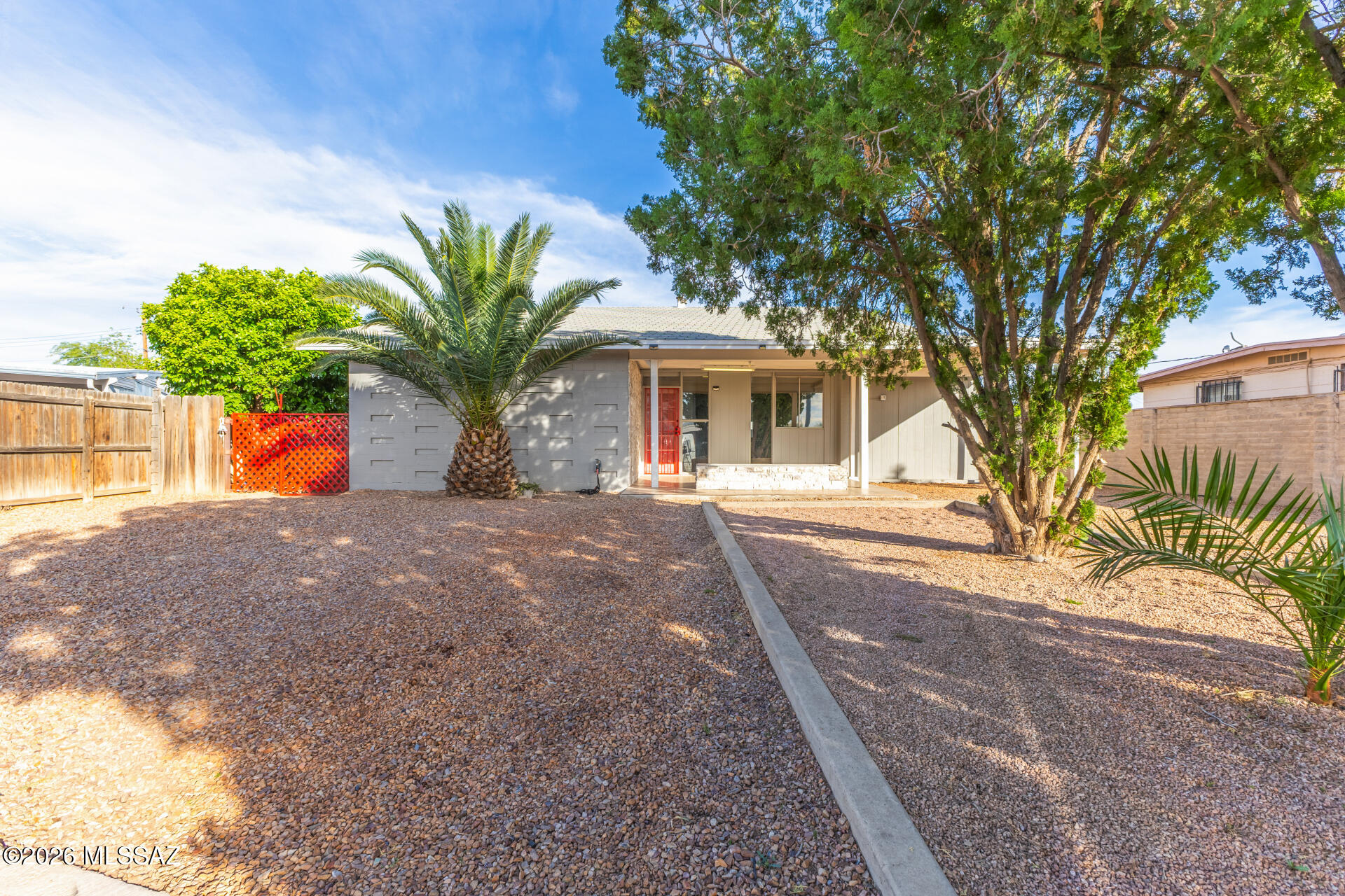 Fantastic opportunity to own this charming single-level 3BD/2BA home in Tucson! Sits on a cul-de-sac, displaying a carport parking, front porch, & a low-maintenance front yard w/trees. The inviting interior features abundant natural lighting, neutral paint, and tile flooring throughout. You'll love the seamlessly flowing layout, ideal for everyday living & entertaining! The kitchen boasts SS appliances, granite countertops, herringbone tile backsplash, and ample wood cabinetry w/crown molding. This home is great for anyone looking to enjoy easy living. Check out the spacious backyard with a covered patio, artificial turf, in-ground deck, and an RV gate from alley access! The attached storage room is a plus. Close to schools, shopping, dining options, parks, & freeways. Don't miss out!