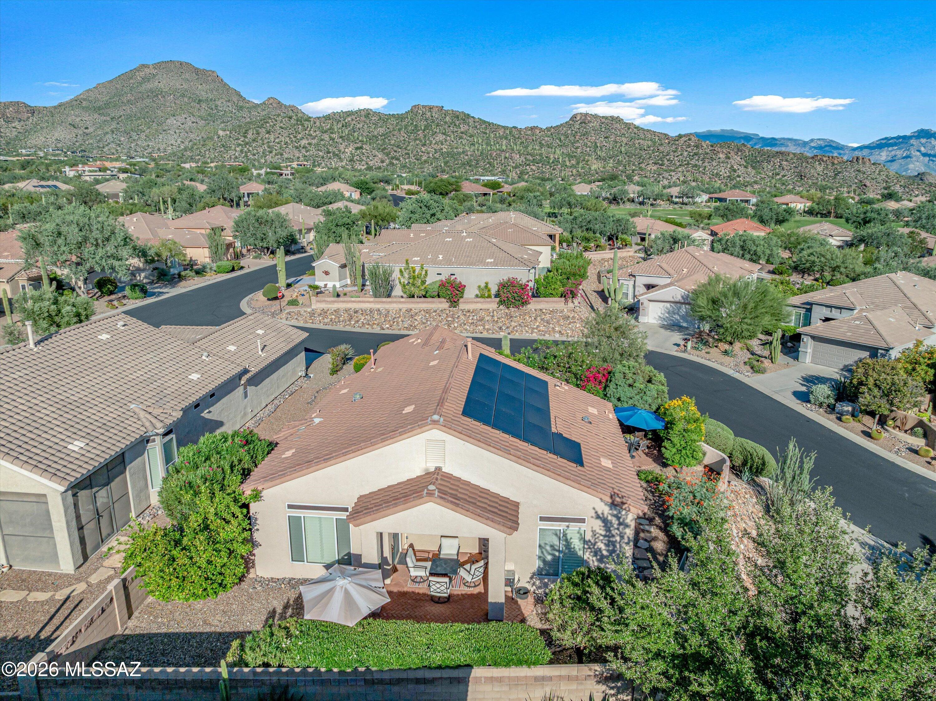 Enjoy the Dove Mountain lifestyle in this well-maintained home located within an active adult community offering pickleball, tennis, fitness facilities, a pool, social activities, and more. Situated on an elevated lot, the home offers a welcoming paver-finished front courtyard that creates a private outdoor gathering space and a beautiful entry to the home. The backyard continues the outdoor living experience with a covered patio and extended paver area, providing plenty of room for dining, entertaining or simply enjoying the surrounding desert landscape and mountain scenery.

Energy efficiency is another highlight, with an existing solar system and low monthly payments that can help reduce energy costs. The HVAC system was replaced in December 2020.

Inside, the thoughtfully designed kitchen features cherry cabinetry, granite countertops and a tile backsplash, while tile flooring and plantation shutters add a timeless touch throughout the main living areas. The primary suite includes dual vanities, a custom-tiled shower and a generous walk-in closet. A versatile guest room/office offers a built-in Murphy bed, desk and shelving, making it easy to accommodate guests while maintaining a functional workspace.

Set in the Dove Mountain area, this home is close to multiple golf clubs, the Ritz-Carlton Dove Mountain resort, dining, recreation and the scenic Sonoran Desert. With mountain views, inviting outdoor spaces, and a community designed for an active lifestyle, this home offers a wonderful opportunity to enjoy low-maintenance living in one of the area's most desirable settings.