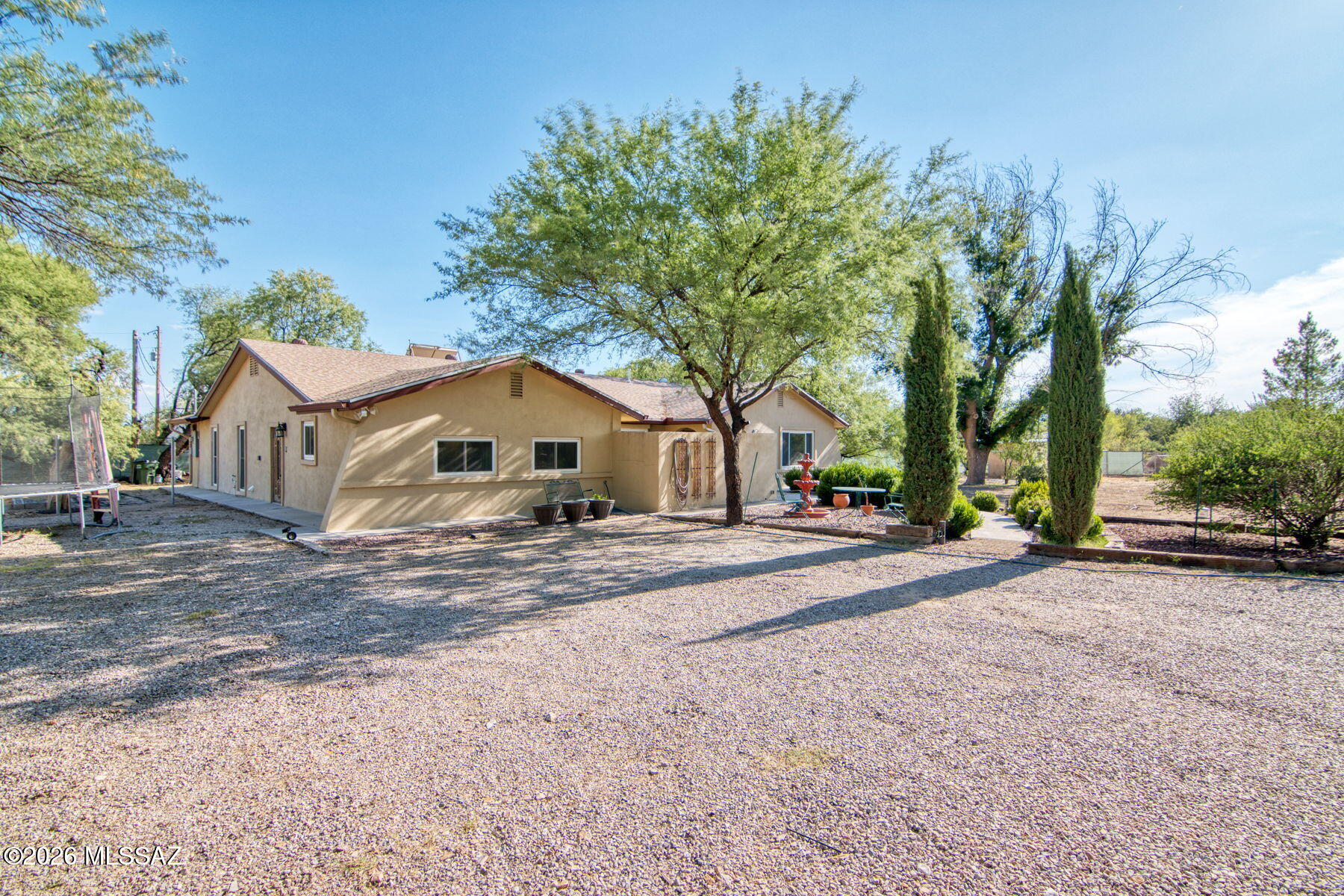 Welcome home to your beautiful 4/2 on over 2 acres with no HOA! Upgraded dual pane windows, updated bathroom, metal stud walls, upgraded 5 ton HVAC, updated gourmet kitchen with new counters, double electric ranges, refrigerator included, and also features a massive walk-in pantry with a utility sink!  Primary comes complete with 2 large walk-in closets and a gas fireplace! Lots of storage throughout the house. The exterior has massive mature trees, including pecan, peach, nectarine and pomegranate trees which all can be watered with the private irrigation well! The property is fully fenced! Relax outside on the large patio, enjoy raising chickens with a full chicken coop, and tend your raised vegetable garden! Tons of parking with a 12'x24' storage shed/workshop. So many options! The well is unused currently and unregistered, but could be used to water the landscaping. There is a separate concrete pad with power, water and gas running to it, plus a small unfilled pond. The storage shed has a garage door on one side and could be used for multiple purposes. Two chickens and one rooster currently occupy the fully fenced chicken coop. They have been on the property for a while and are accustomed to the premises so they may convey with the property if desired. Flood insurance runs about $100/month.