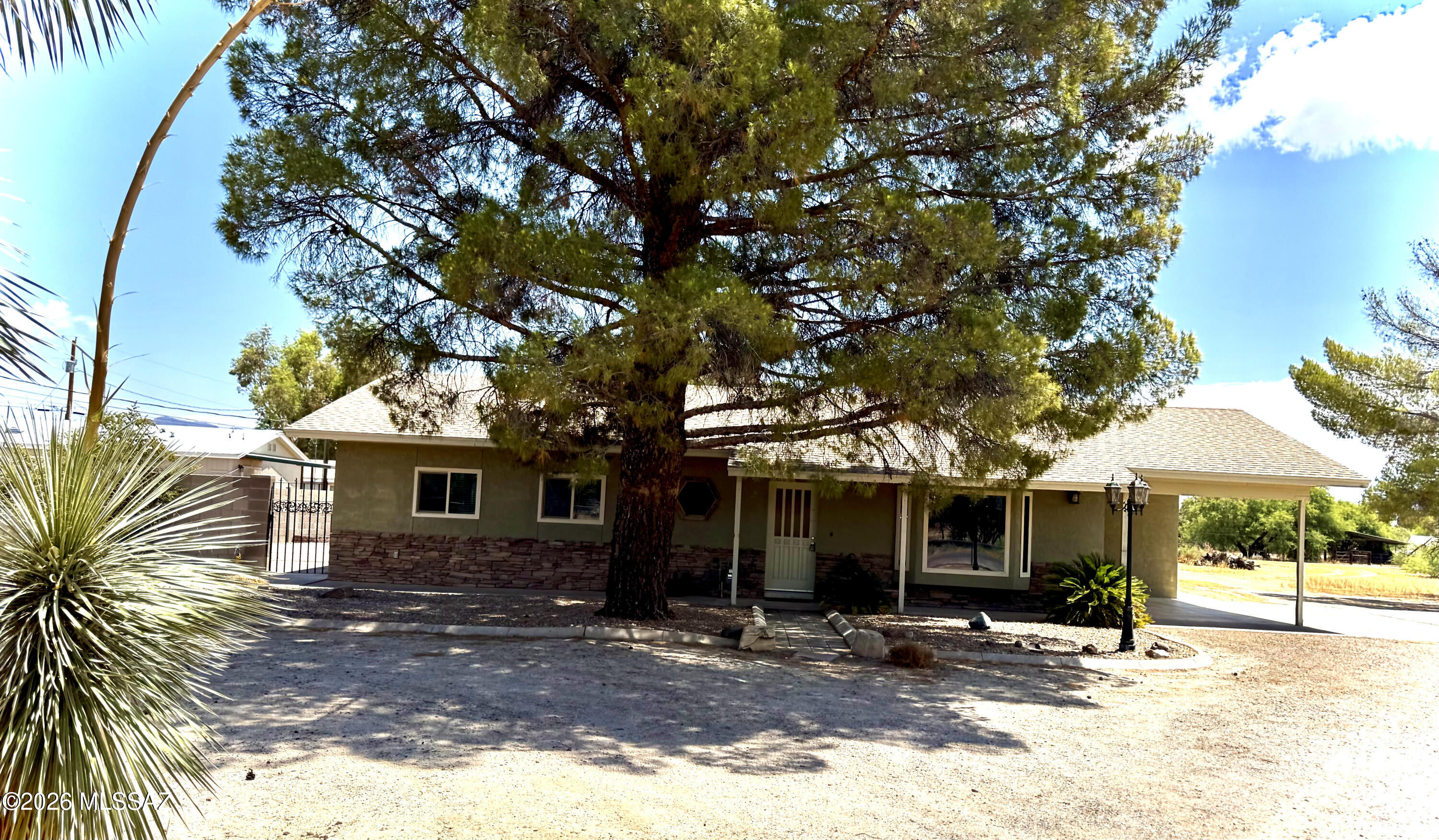 Here is your chance to have just over 1 acre of horse property in Thatcher, Az. This house features a basement with lots of room, and storage.  The front of the house has a circle drive Giving lots of room for parking including the one car, carport and large cement slab. The updated kitchen has granite countertops, stainless steel appliances, and LVP wood floors.  This house also has room for a normal dining room off the kitchen.  With five bedrooms and three baths, it has plenty of room to spread out.  Fireplace in basement keeps it nice and warm in the winter.  Do not miss taking a look at this house, and making it yours.  Recently painted throughout home!
