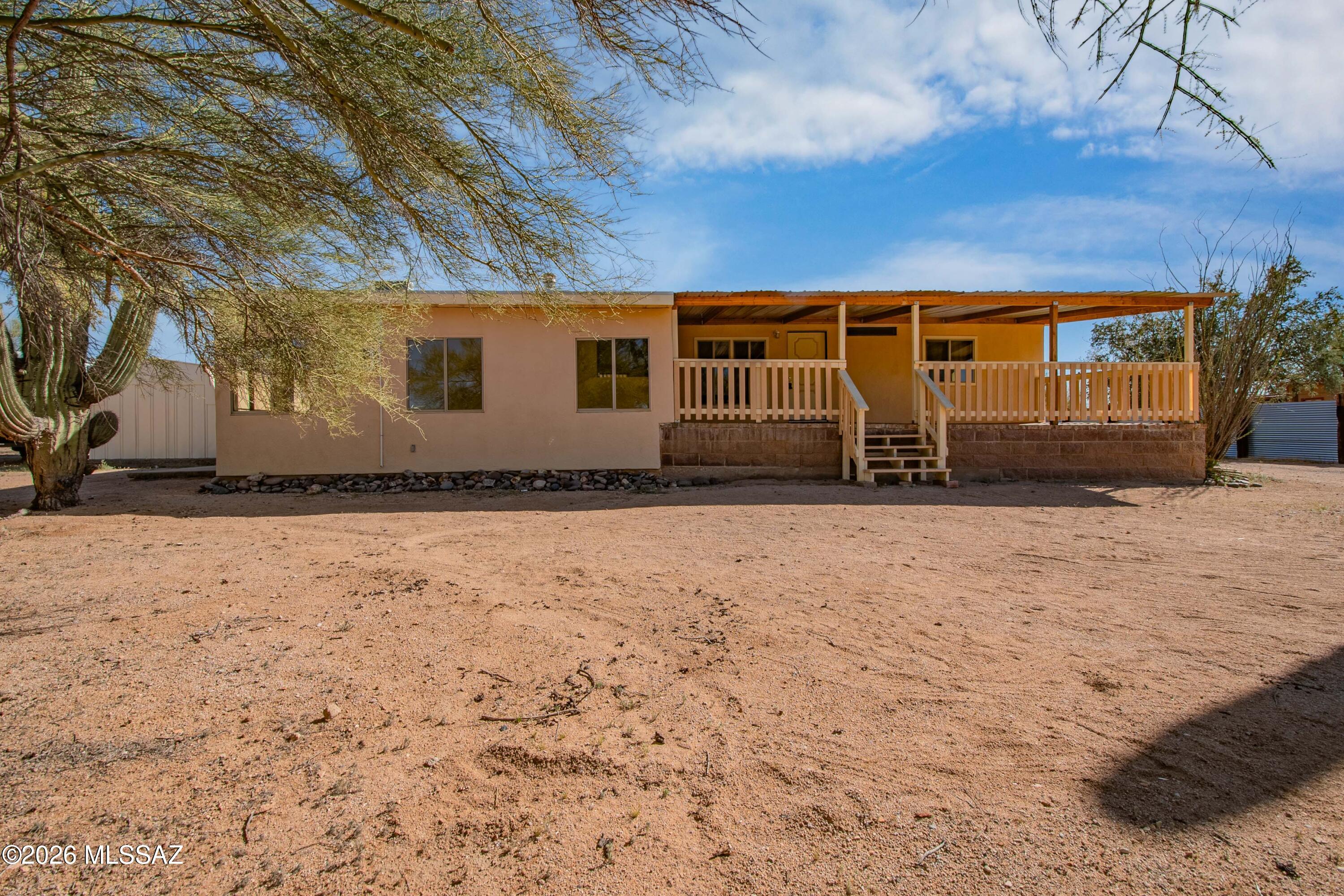Experience quiet country living in this 3-bedroom, 2-bath manufactured home set on a spacious lot with room to enjoy the outdoors. A large covered front porch welcomes you and provides the perfect place to relax while taking in the surrounding landscape. Inside, the home offers a bright open-concept layout that brings together the living room, dining area, and kitchen, creating a comfortable space for everyday living and entertaining. Natural light fills the main living areas, enhancing the warm and inviting feel of the home. The kitchen provides plenty of space for cooking and gathering. At the front of the home, a bonus room adds extra flexibility and could easily serve as a game room, additional living area, media room, or hobby space depending on your needs. The primary bedroom includes a walk-in closet and private en-suite bathroom, while two additional bedrooms and a second full bathroom offer flexibility for family, guests, or a home office. Outside, the property features a spacious workshop/carport, ideal for projects, equipment storage, or a shaded work area during the summer months. The large lot provides plenty of opportunities for outdoor activities, gardening, or simply enjoying the peaceful setting. Located with convenient access to nearby amenities, this property offers the comfort of rural living while remaining close to everyday necessities. Schedule a showing to see everything this home has to offer.