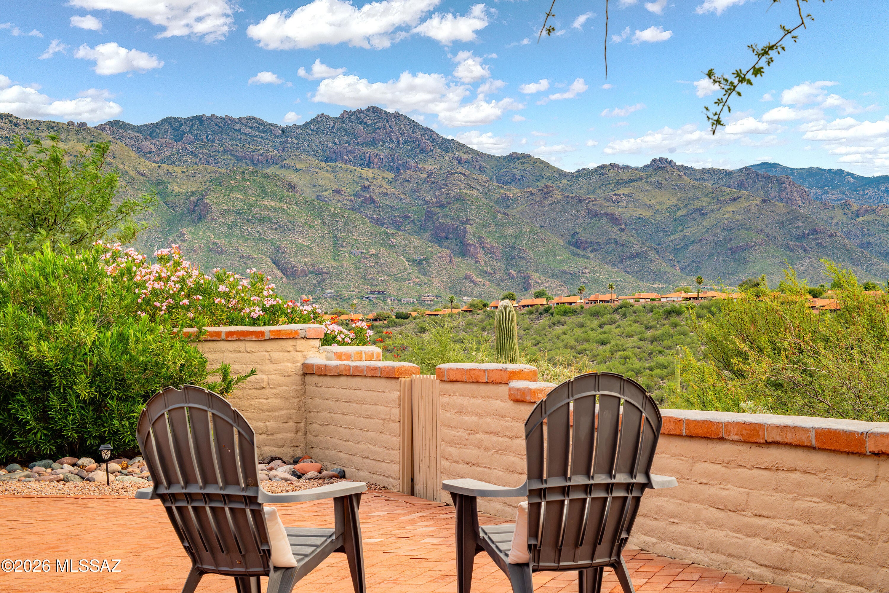 The glorious views of the Catalina and Rincon Mountains from this lovely home cannot be understated! Located in the highly desirable Sunrise Ridge, this Fairfield home is perched atop the hill overlooking lush desert and beautiful sky. At 1611sqft, this 2-bedroom, 2-bathroom split floor plan home offers a versatile layout, generously sized rooms and quality lifestyle. The kitchen features ample counterspace, tile backsplash, breakfast bar; illuminated by natural light it opens to living areas, creating a cohesive yet distinct feel. From a comfortable seat in your living room, watch the mountains turn pink, a summer storm roll in or an enchanting fire in the wood burning fireplace. From your front courtyard, chat with friendly neighbors and watch a beautiful desert sunset on the Catalinas. Off the Living and Primary Bedroom is the east-facing patio and expansive, low-maintenance, private back yard with mountain and views and no rear neighbors behind. In the large Primary Suite, you'll find a walk-in closet, dual vanities, natural lighting and walk-in shower. The sizable second bedroom is perfect retreat for guests, a hobby room or office big enough for two. Enjoy large format tile throughout the living spaces, carpet in the bedrooms, dual pane windows throughout, a freshly coated roof, newer water heater, regularly maintained HVAC and smart thermostat. In the 2-car garage includes also offers a washtub and additional storage space. Your experience and the community is enhanced by a pool, spa and tennis courts. A nearby walking path weaves though natural desert and stretches to Craycroft. Not only will you feel immersed in Tucson's beauty, but amenities are located conveniently close; the best of both worlds!