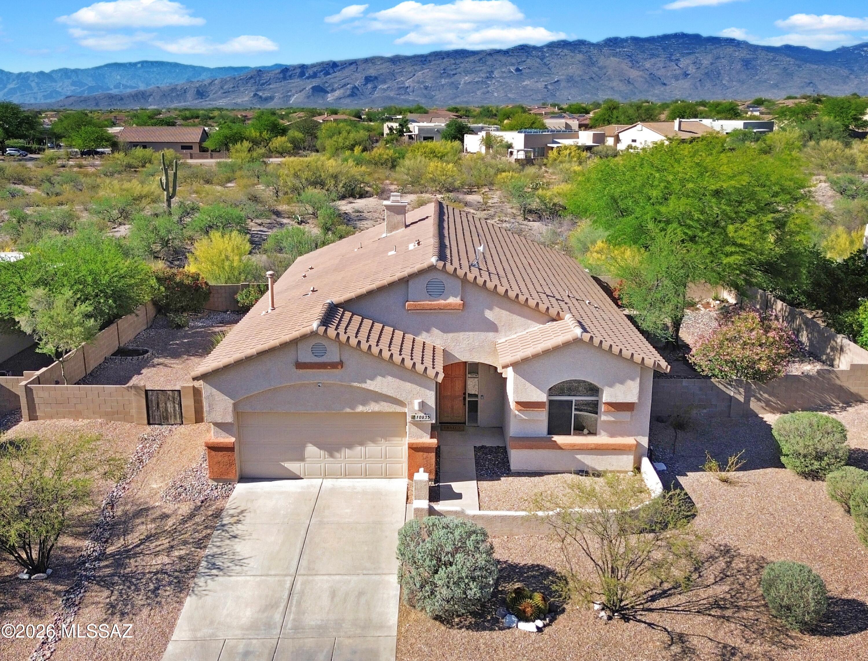 Save thousands with possible 4.99% VA assumption! The neighborhood and house you've been swiping to find is finally on the market! Convenient to I-10, Vail's esteemed schools and amenities moments away yet still a tranquil oasis away from it all. Large lot and no neighbors behind in this luxurious enclave. From the front entry courtyard, the north facing picturesque mountain views framed by expansive windows draw you through the spacious open concept living areas. High ceilings, bee-hive fireplace, and a thoughtful spilt layout grants ample space and luxury finishes to everyone. The chef's kitchen lacks for
nothing with quartz, high end appliances and miles of prep space with sightlines to the yard for a seamless indoor/outdoor entertaining lifestyle. A spacious primary/ensuite replete with dual vanities, separate makeup area and views that will start your day in peaceful style. Luxury, location, space, creature comforts... the only thing missing here is you!