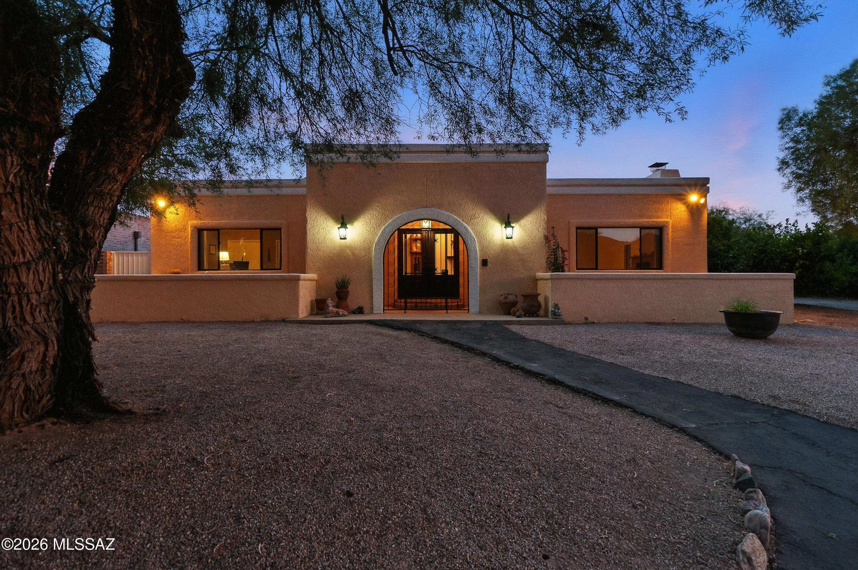 Exceptional home inside the gates of Tucson Country Club!  Situated on over 1/3 of an acre, the open, 2348 sq ft light-filled floor plan features laminate wood floors, updated guest baths, recent A/C & water heater, a generous living room w/ brick fireplace & spacious family room flowing from the kitchen that opens to the outdoor private screened retreat. Kitchen boasts quartz counters, cherry cabs and Kitchen Aid stainless appliances. Primary suite w/ updated bath and gorgeous shower. Spacious backyard is made for fun with a newer lap pool w/ real grass lawn. Plenty of parking with a large driveway plus 2-car garage with storage. Close enough to the club to drive your golf cart to the clubhouse! A rare find on a quiet cul-de-sac in TCC!