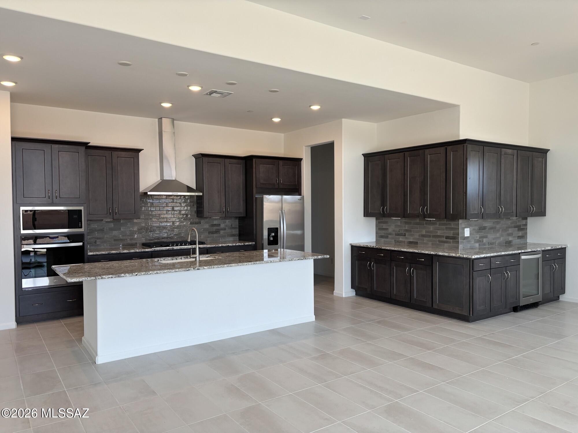 Charming Hunter plan with Desert Modern elevation features open layout with Greatroom, dining area & kitchen. Also includes covered back patio with 12' sliding glass door to bring plenty of natural light. Gourmet kitchen boasts gas cooktop, tons of counter space, cushion-close drawers, huge walk-in pantry. Owner's suite is a beautiful retreat with a generously sized walk-in closet, a beautifully tiled walk-in shower, vanity with twin sinks and linen closet. Enclosed Study provides office, hobby or play space. Convenient Stop-n-Drop area add organization & a place to charge your devices. Includes: tankless water heater, extended covered back patio with gas BBQ stub-out, LED disk lights, granite counters thru out.