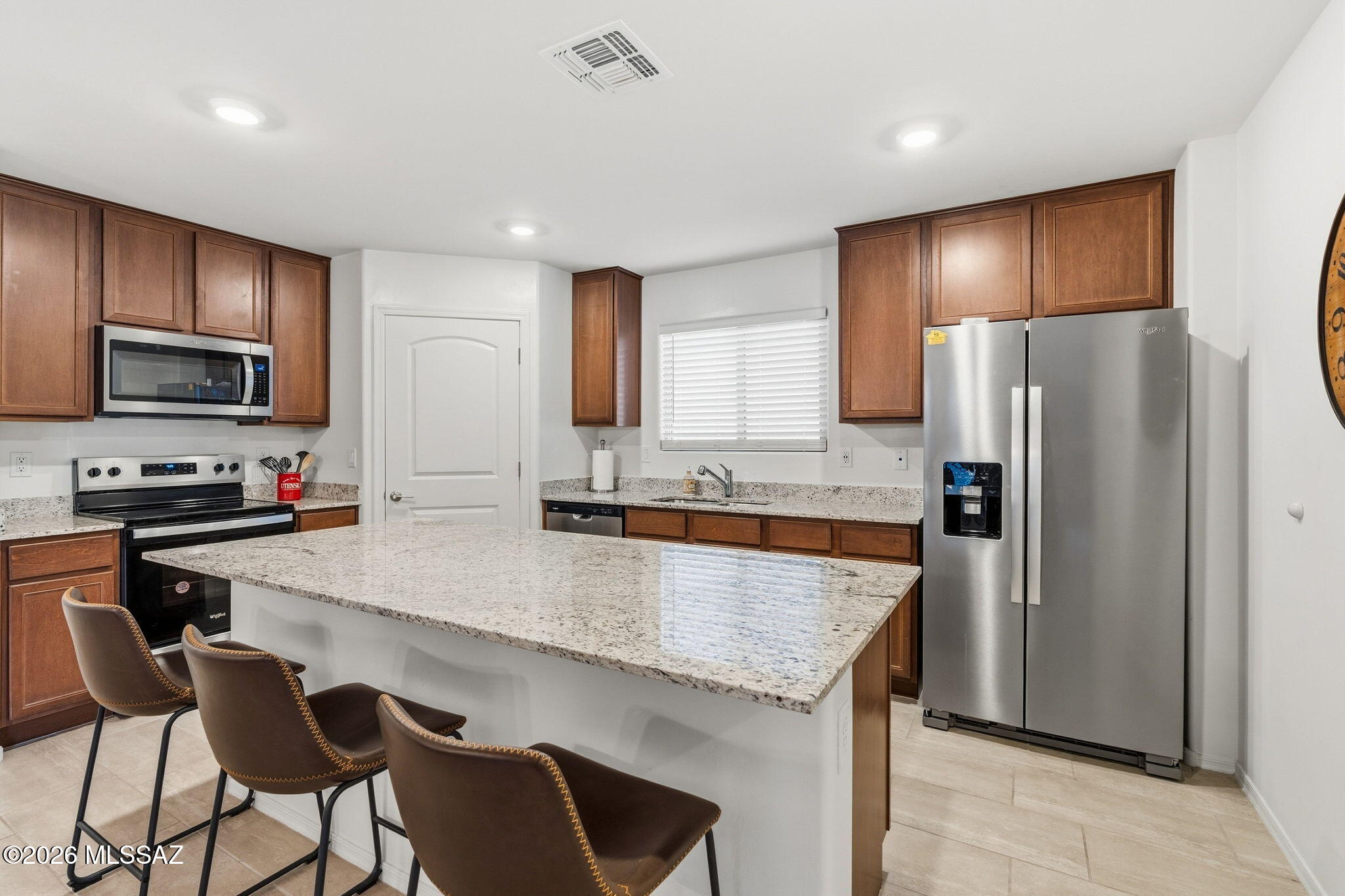 Why wait to build? Your nearly new home awaits in Wildflower Reserve! Built in 2025, this pristine 3-bedroom, 2-bath, 1,465 sq. ft. single-story home combines modern comfort, thoughtful design and the beauty of Northwest Tucson's Sonoran Desert surroundings. Step inside to an open, airy floor plan with 9-ft. ceilings and a spacious Great Room designed for everyday living and easy entertaining. The kitchen sits at the heart of the home and features granite countertops, 42-inch cabinetry, stainless-steel Whirlpool appliances, a large center island with generous seating, walk-in pantry and plenty of prep and storage space. Durable tile flooring throughout the main living areas adds to the home's clean, contemporary feel.
 more... The thoughtfully designed split-bedroom floor plan provides added privacy between the spacious primary suite and two additional bedrooms. The primary retreat features a walk-in closet and private bath with dual vanities and a glass-enclosed step-in shower, while the secondary bedrooms offer flexibility for family, guests, a home office or hobbies.
Step outside to an east-facing covered patio, grass backyard and beautiful Catalina Mountain views, creating a wonderful extension of the home's living space. Low-maintenance desert landscaping in front, a concrete tile roof, block-wall backyard and 2-car garage complete the package.
Wildflower Reserve embraces the Arizona lifestyle with community amenities including a turfgrass area, walking trail and ramada. Enjoy convenient access to the shopping, restaurants, gyms, entertainment and movies of Oro Valley Marketplace, along with the gorgeous Sonoran Desert setting, hiking and outdoor recreation of nearby Catalina State Park.
 Some personal furnishings may convey. Move-in ready! Come experience Wildflower Reserve, Catalina Mountain views and the Northwest Tucson lifestyle!