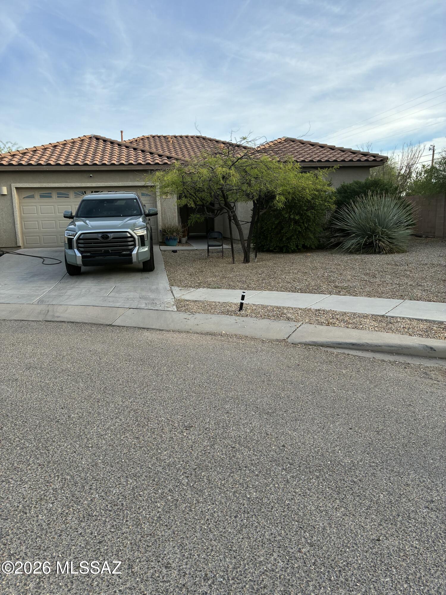 Nestled at the end of a quiet cul-de-sac in a gated Corona de Tucson community, this well-maintained Lennar home offers privacy and top-rated Vail schools. The split-bedroom layout features a primary suite with a soaking tub and separate shower, plus a guest bath with dual sinks. 
The heart of the home shines with granite countertops, maple cabinetry, and ss appliances. Recent upgrades include fresh interior paint, and a finished garage equipped with a 220V EV hookup and MyQ smart opener. Outside, the spacious, private backyard and currently features low-maintenance pavers and artificial turf.