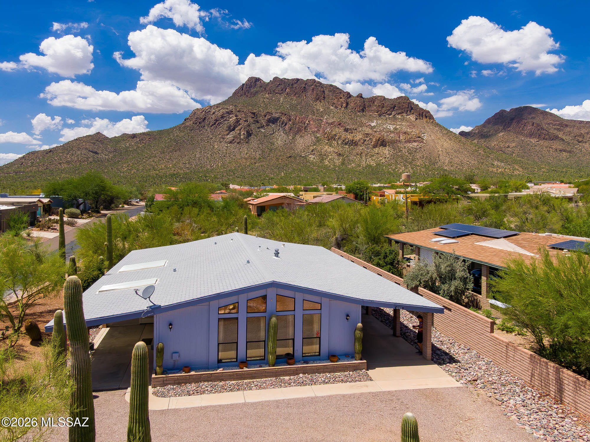 Discover the perfect blend of comfort, recreation, and breathtaking scenery in this charming 2-bedroom, 2-bath home. Located in a gated community, this home sits on a large corner lot with a backdrop of stunning mountain views. Inside, you'll find an open floor plan featuring a spacious living room, & formal dining area with vaulted ceilings. Relax in the generously sized Arizona room while enjoying the peaceful desert landscape. A covered carport with direct home entry and a storage room/workshop add convenience. Ideally located within one mile of six dining options and near hiking trails. HOA amenities include a pool, spa, pickleball, basketball, and tennis courts, plus a community center with scheduled games, activities, and classes. The perfect full-time residence or Arizona getaway.