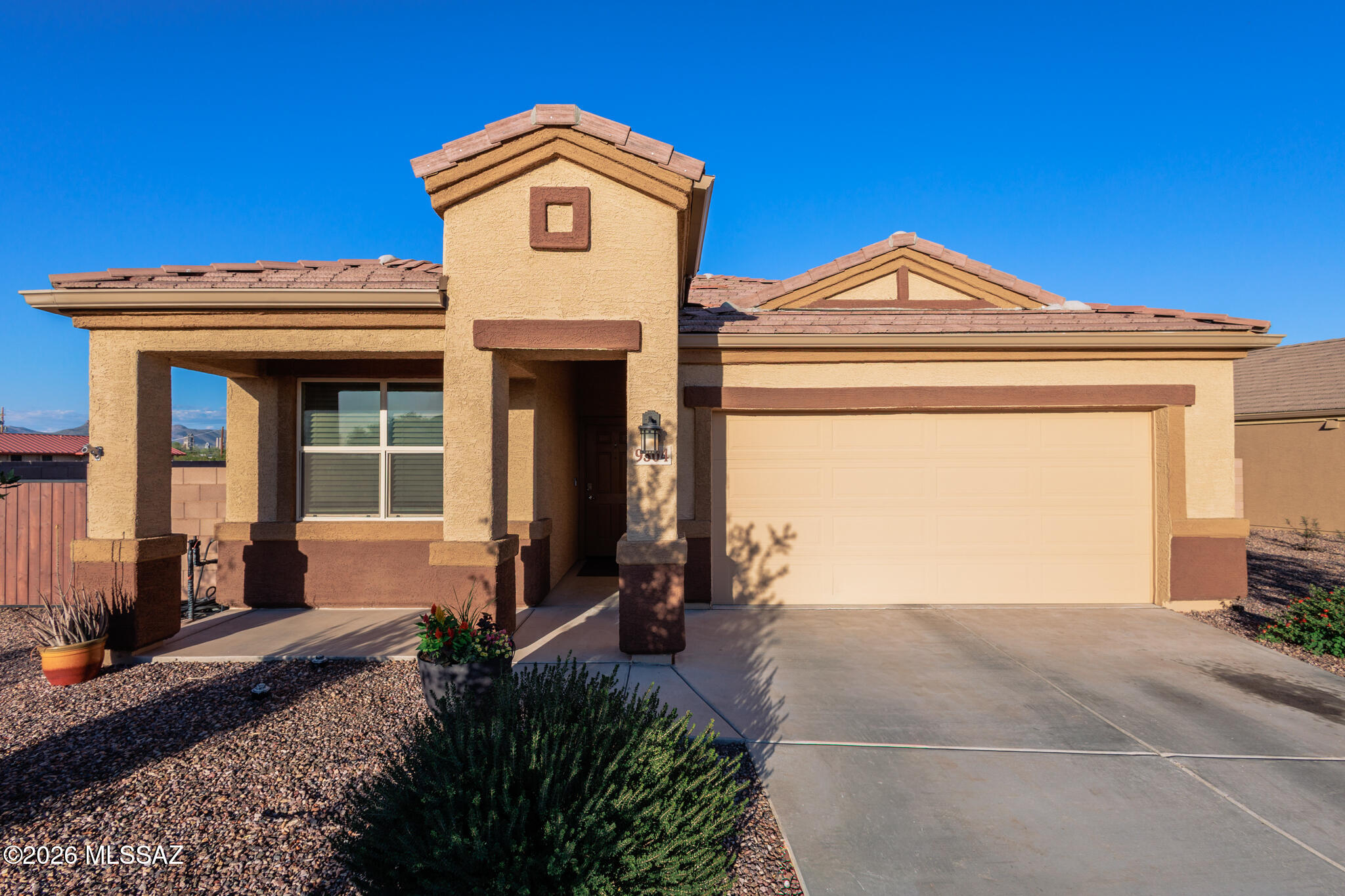 Exceptional 4 bedroom, 2 bath home in sought-after Saguaro Bloom, perfectly positioned on a premium cul-de-sac lot offering enhanced privacy and scenic surroundings. This semi-private homesite features only one neighbor to the right and no neighbors directly behind, allowing you to enjoy beautiful mountain views from the backyard. Situated on a larger lot, the property offers added space and flexibility, along with a gate on both sides for convenient backyard access. Inside, the open-concept floor plan provides bright, comfortable living areas with no carpet in the main living room for easy maintenance. The updated laundry room features custom cabinetry, while the epoxy-coated garage floors add a clean, finished look. A water softener is also included. Step outside to a thoughtfully designed backyard with extended paver patio and real grass, perfect for relaxing or entertaining. Located within the Marana Unified School District, Saguaro Bloom offers desirable community amenities including parks, playgrounds, walking paths, sports courts, and a splash pad, all while being conveniently close to shopping, dining, and everyday conveniences.