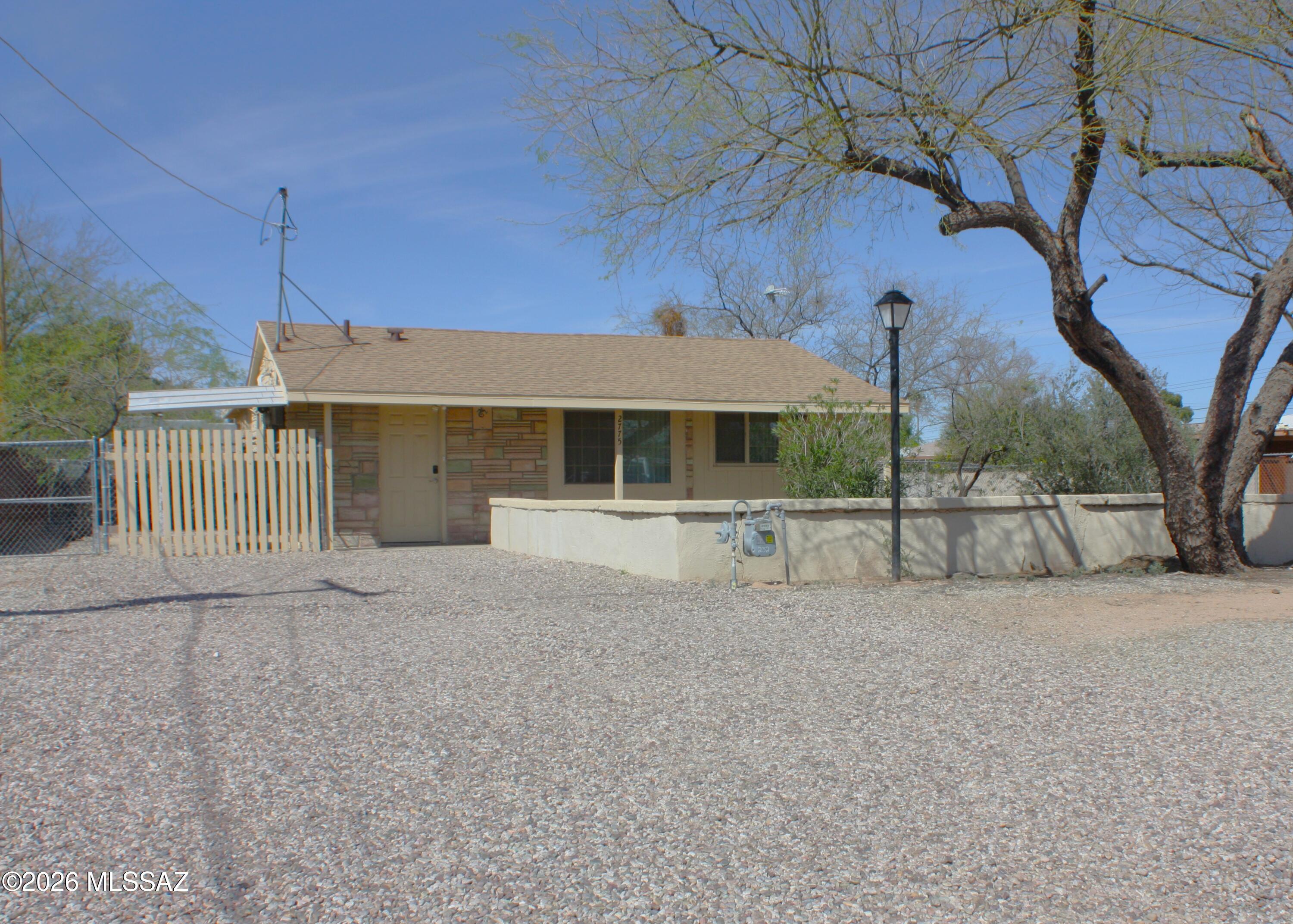 Multigenerational home features one year old roof, new paint, fenced yards, storage sheds, patio, and dog kennel.  Kitchen has refrigerator, and microwave oven that stay with property.  Cozy kitchen nook overlooks front yard.  Tile floors flow throughout the home.  Master bedroom boasts a large closet.  Second bedroom has a room off of it for a kitchenette, a bath, and can be separated from balance of home by 2 doors that are stored in shed. Most windows are duel pane.  Property is close to schools, public transportation, and shopping.