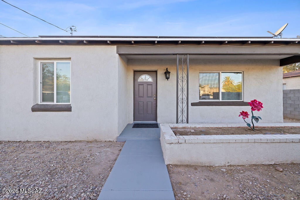 Welcome to 3632 S Lundy Ave, a 3 bedroom, 2 bathroom home with 1,385 sq ft in Tucson. Rooftop solar panels and a charming front yard greet you at the street. Inside, wood-look flooring runs throughout the main living areas. The updated kitchen has white cabinetry, granite countertops, a tile backsplash, stainless steel appliances, and a butcher-block prep area. The layout offers flexible space, with multiple open living areas. Ceiling fans in the bedrooms and living spaces keep things comfortable, and a dedicated laundry room has space for storage. Outside, the large backyard has mature trees, palms, and a covered patio, with plenty of room to entertain, garden, or park a toy or two. Close to shopping, dining, and major routes. Don't miss it!