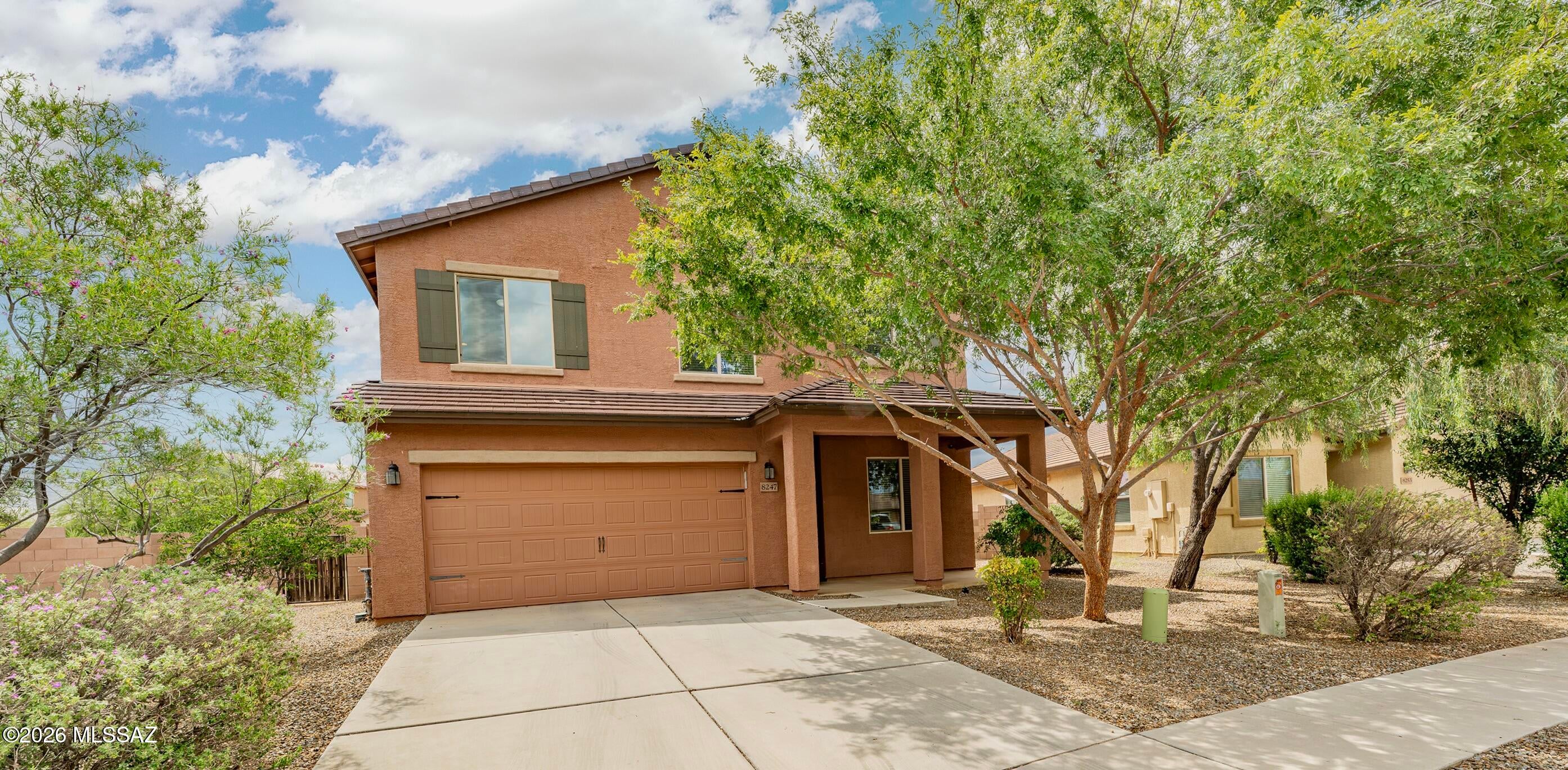You'll feel at home in this impeccable 5-Bedroom, 3-Bath Sonoran Ranch Estates home the moment you walk in! As you enter, pass the quaint living room on the right (with lovely landscaped community open space in view) or continue to the spacious and open great room, kitchen, and dining area. Enjoy a ground-floor bedroom and adjoining bath, offering ease for a resident or guest who prefers to stay downstairs. Step outside to the adjoining back patio and expansive backyard, offering seamless indoor-outdoor living and endless possibilities for the new owner. At the top of the staircase, find so much more: A generous landing leading to four additional bedrooms, including the primary bedroom/bathroom ensuite (with an incredible walk-in closet), also a full bath with a dual vanity serving upstairs bedrooms, a flex-space loft, and a laundry room--close to  bedrooms. The many extras in this home include a cook's kitchen with quality appliances, granite countertops, plentiful workspace, and a large pantry; good lighting throughout the home; a generous .2 acre home lot with excellent space between neighbors, sidewalks in the community, and a beautiful neighborhood park. Last but not least, mountain views and an impeccable garage to match the home. Easy commute to I-10, Tucson International Airport, Raytheon, Casino del Sol, and more. Plentiful shopping and dining along Valencia, both east and west of I-10. This may be your new Tucson home!
