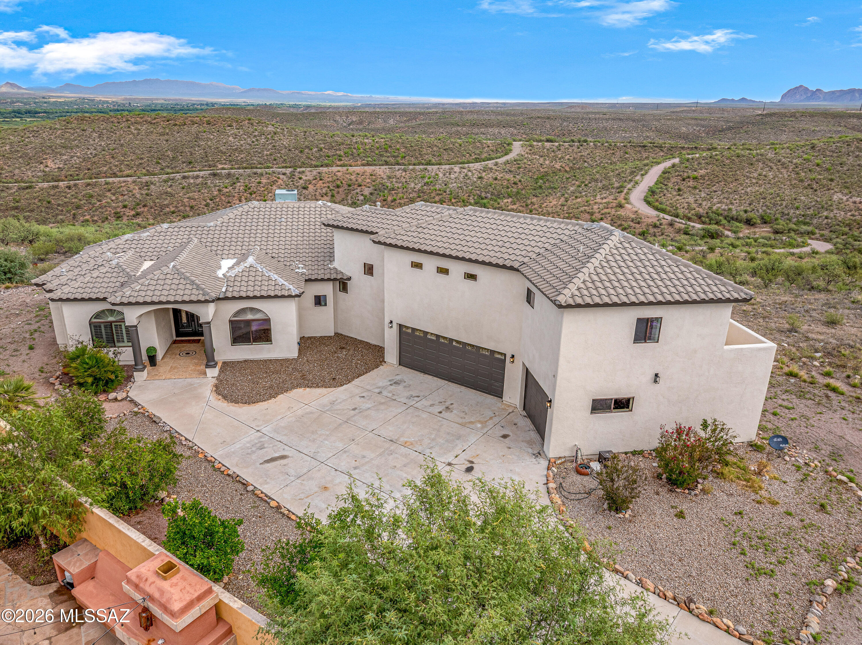 She's BACK & better than ever! A rare combination of land, views, flexibility & value all within a sought-after gated setting. 1.79 acres, sweeping views of the Santa Rita Mountains. This thoughtfully designed home offers spacious indoor/outdoor living with vaulted ceilings, tile flooring & custom finishes throughout. The kitchen features granite countertops & backsplash, stainless steel appliances, oversized passthrough, & a bright adjoining dining area. Main-level flex space is perfect for an office, den, media room, or guest room. Upstairs, the primary suite includes a private balcony-the views!!! dedicated office nook & spa-style bath w/dual sinks, jetted tub & separate shower. Enjoy covered patio plus a triple-bay garage & additional parking pad for RV or boat.