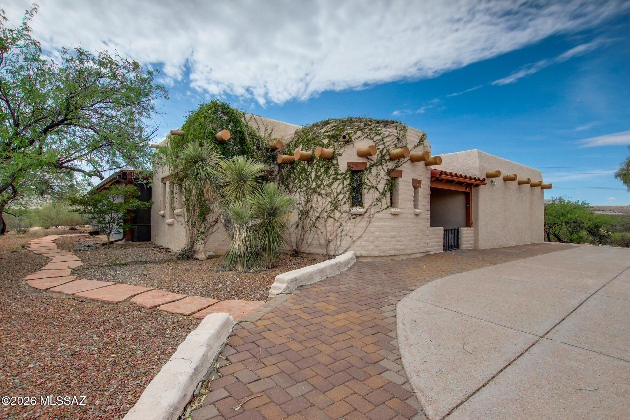 Nestled on over 4 acres of serene desert landscape, this unique Green Valley property offers the perfect blend of privacy, space and beautiful Southwest charm. The main home features 2 bedrooms and 3 bathrooms with an inviting layout, abundant natural light as well as multiple living areas designed for both comfort and entertaining.
Enjoy cozy evenings by one of the three wood burning fireplaces or relax in the Arizona room while taking in the peaceful surrounding views. The property also includes a separate guest house, ideal for visitors and great multi-generational living. With no HOA, a circular driveway, and ample space for outdoor living, this home provides endless opportunities to create your own desert retreat. A rare find combining acreage, versatility, and value in a highly desirable location.
