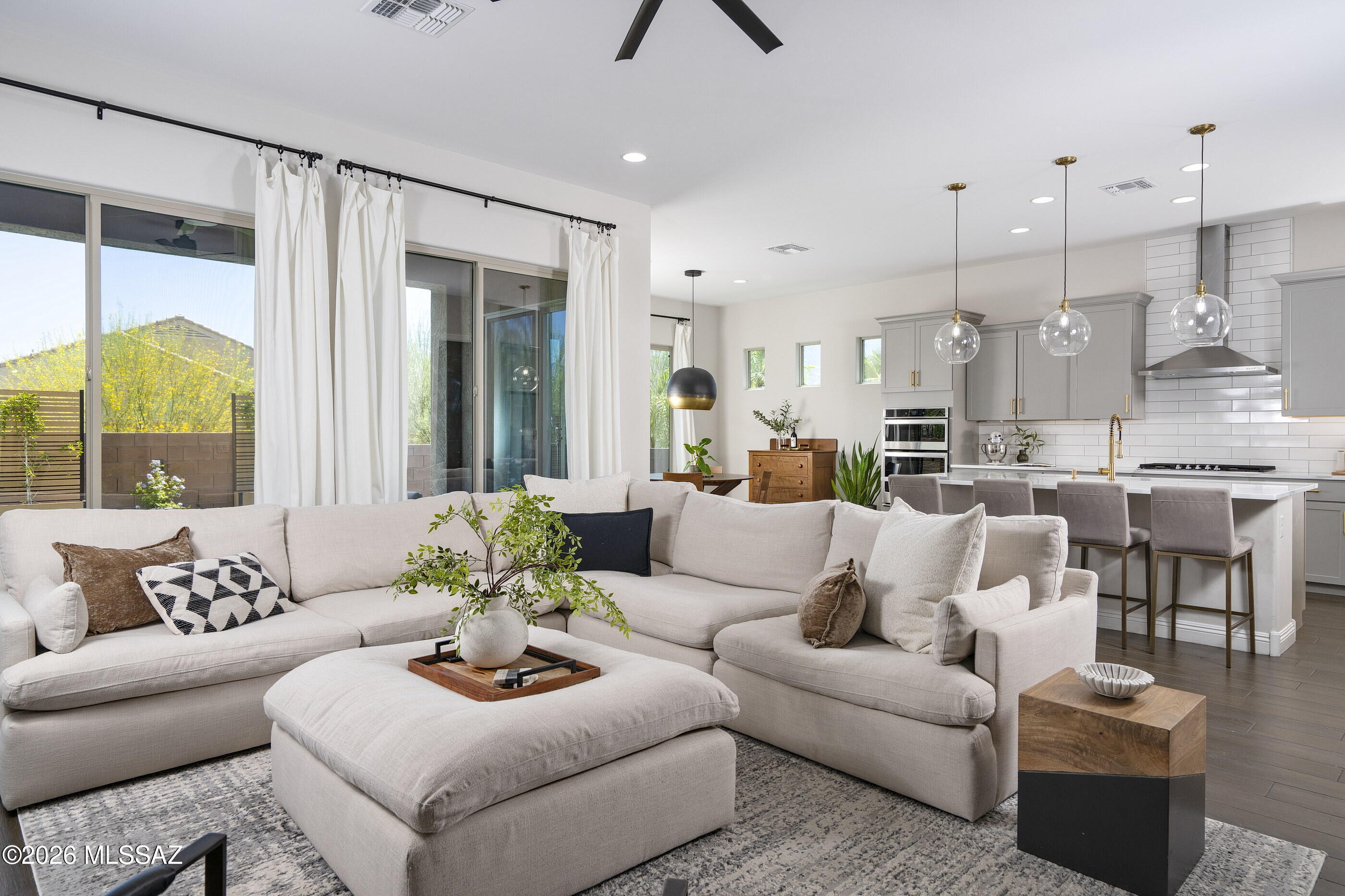Tucked away on a cul-de-sac in the sought-after Valley Vista neighborhood of Rancho Vistoso, this beautifully appointed Pulte residence offers a seamless blend of comfort, style, and desert serenity. A private courtyard entry sets a welcoming tone, leading into light-filled interiors where soaring ceilings, luxury plank tile flooring, and an open-concept design create an atmosphere that is both sophisticated and inviting. The heart of the home is a spacious kitchen featuring a generous center island, walk-in pantry, and casual dining nook with direct access to the outdoor living spaces. Open to the great room and dining area, it serves as the natural hub for everyday living and effortless entertaining. Thoughtfully designed with a split-bedroom floor plan, the primary suite occupies its own private wing, offering a peaceful retreat complete with a spa-like bathroom, quartz countertops, walk-in shower, and expansive closet. On the opposite side of the home, three additional bedrooms provide flexibility for family and guests, including a private en-suite bedroom and a versatile bonus space ideal for a home office, media room, or fitness studio.

Outside, the backyard embraces the beauty of the surrounding landscape. A covered patio extends the living experience outdoors, where sweeping mountain views provide a stunning backdrop for morning coffee, evening sunsets, and gatherings around the fire pit. Low-maintenance and thoughtfully designed, the outdoor spaces invite year-round enjoyment of Southern Arizona's exceptional climate.

Combining modern comfort with a coveted Rancho Vistoso setting, this residence offers an elevated lifestyle in one of Oro Valley's most desirable communities.