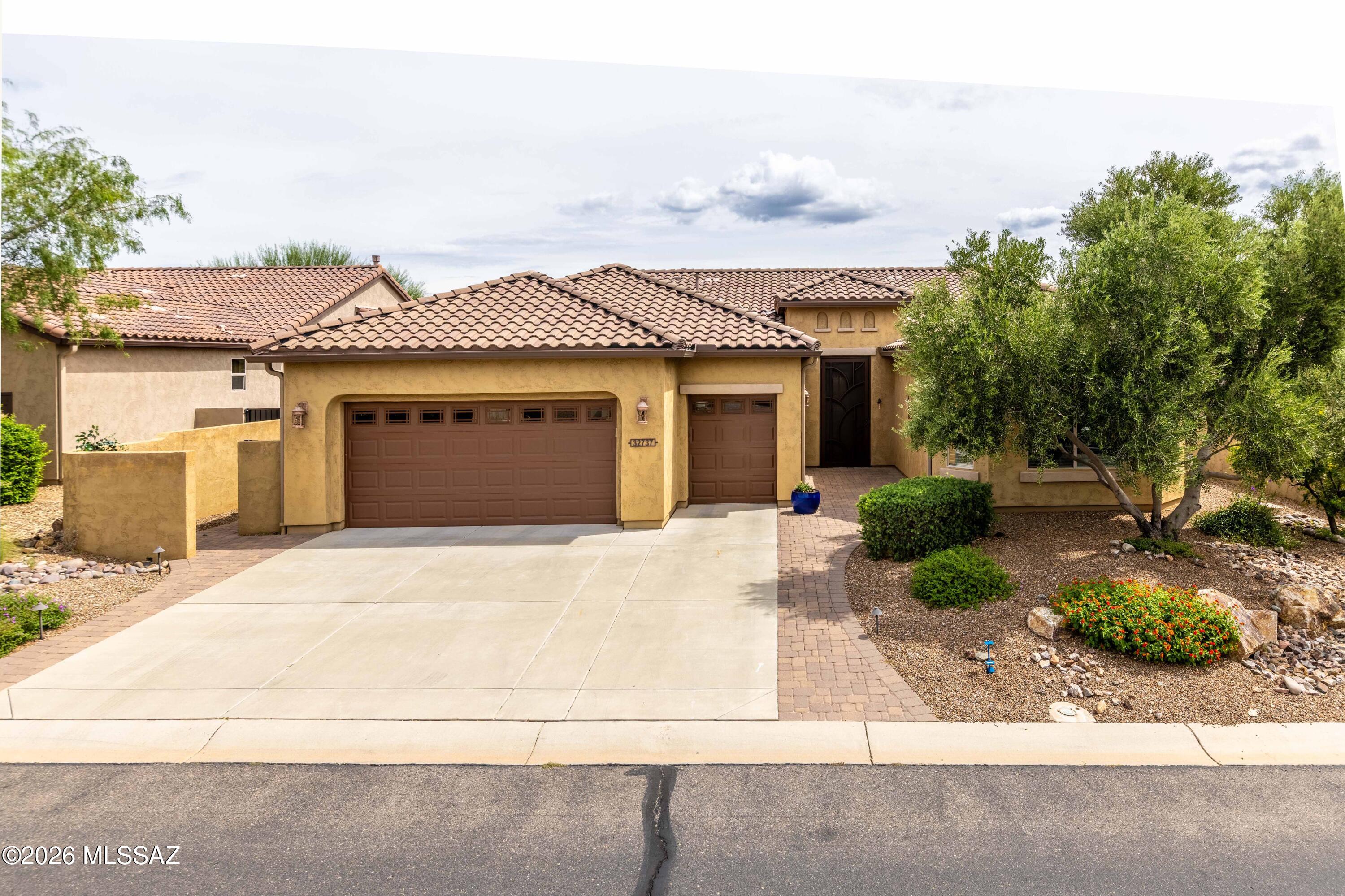 An incredible 2,195 Sq. Ft. Cortez Model Elevation Design C located on a large lot (.26 Acres).This home consists of 2-Bedroom En Suites; Powder Room; Great Room with Built-Ins in the Media Alcove; Dining Room; Spacious Den; Grand Kitchen Island w/Walk-In Pantry w/Gas Range; Master Suite has Optional Bay Window, 42'' X 60'' Shower w/Built-In Seat and Custom-Shelving in the Walk-In Closet; 2nd Bedroom has a Walk-In Closet, Shower only and Optional Bay Window; Separate Laundry Room; 9' and 11' ft. ceilings throughout this lovely home! The garage has Epoxy Coating, the Optional Service Door w/Screen Door, Water Filtration System, Mini-Split Air Conditioning, the Optional Garage 4' Extension, the Optional Golf Cart 4' Extension, the Optional Sink, and the Optional Rear Garage Extension. The Front yard is beautifully landscaped and fully irrigated. The large Backyard has Raised Garden Beds/Boxes, Fire Pit, Above Ground Spa, Irrigation, and is fully fenced. The 192' Sq. Ft. Covered Patio has been extended from the side of the house and across the Outdoor Living Space and the Dining Room + Rolling Shades have been added to all three openings + has an Outdoor Fireplace (Natural Gas)!
