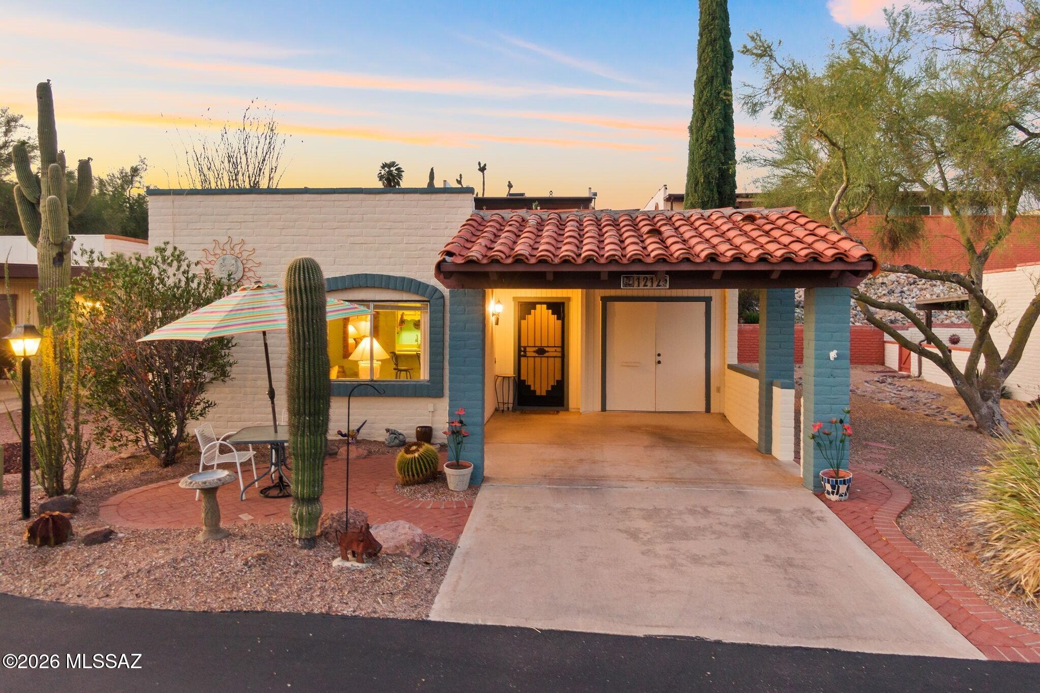 This 2 bedroom, 2 bathroom townhome offers a thoughtful layout with an added Arizona room, creating flexible space for everyday living. It works easily as a second living area, office, hobby space, or a comfortable spot for guests.

Inside, the home feels warm and inviting with natural light throughout and an easy flow between the living room, dining area, and kitchen. The spaces feel open but still defined. Tile flooring runs throughout for simple upkeep, and the kitchen offers ample cabinet storage with a clean, well-kept feel.

The Arizona room is a standout feature with a wall of windows looking out to the greenery, creating a quiet, sunlit space to relax. The primary bedroom includes a corner window that connects toward this room, adding even more light and a subtle architectural detail that gives the home character.

Out front, you'll find mature desert landscaping, soft mountain views, and a peaceful setting that's easy to enjoy morning or evening. It's a comfortable, low-maintenance setup that works well year-round or as a seasonal retreat.

Desert Hills II is a well-kept 55+ community known for its quiet atmosphere, easy layout, and convenient location near shopping, dining, and quick access into Tucson. Green Valley Recreation amenities are also available, offering pools, fitness, pickleball, and a variety of social activities.
The home can be sold fully furnished, making it simple to move right in or begin using as a seasonal or rental property.

A well-cared-for home with a warm, easy feel and just the right amount of extra space.